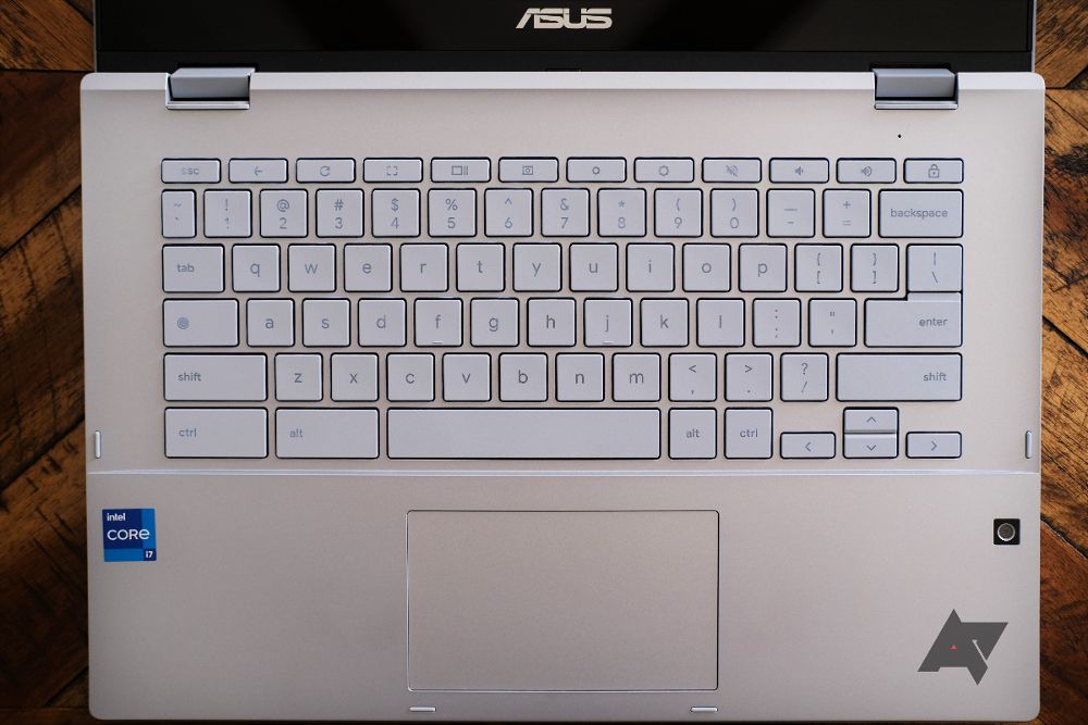 A Chromebook Flip CX3400's keyboard with a wooden table in the background