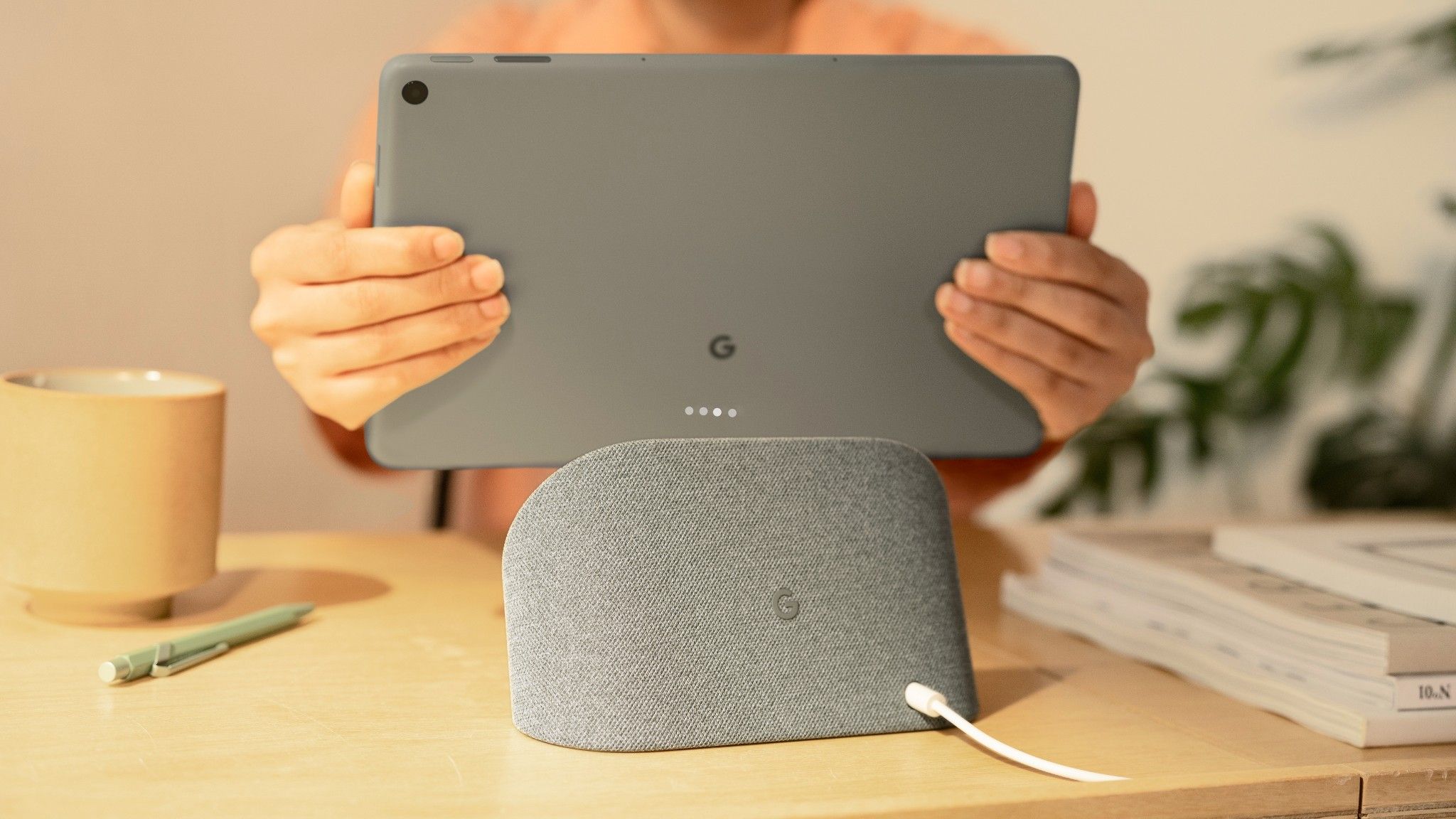 A tablet being removed from its charging dock.