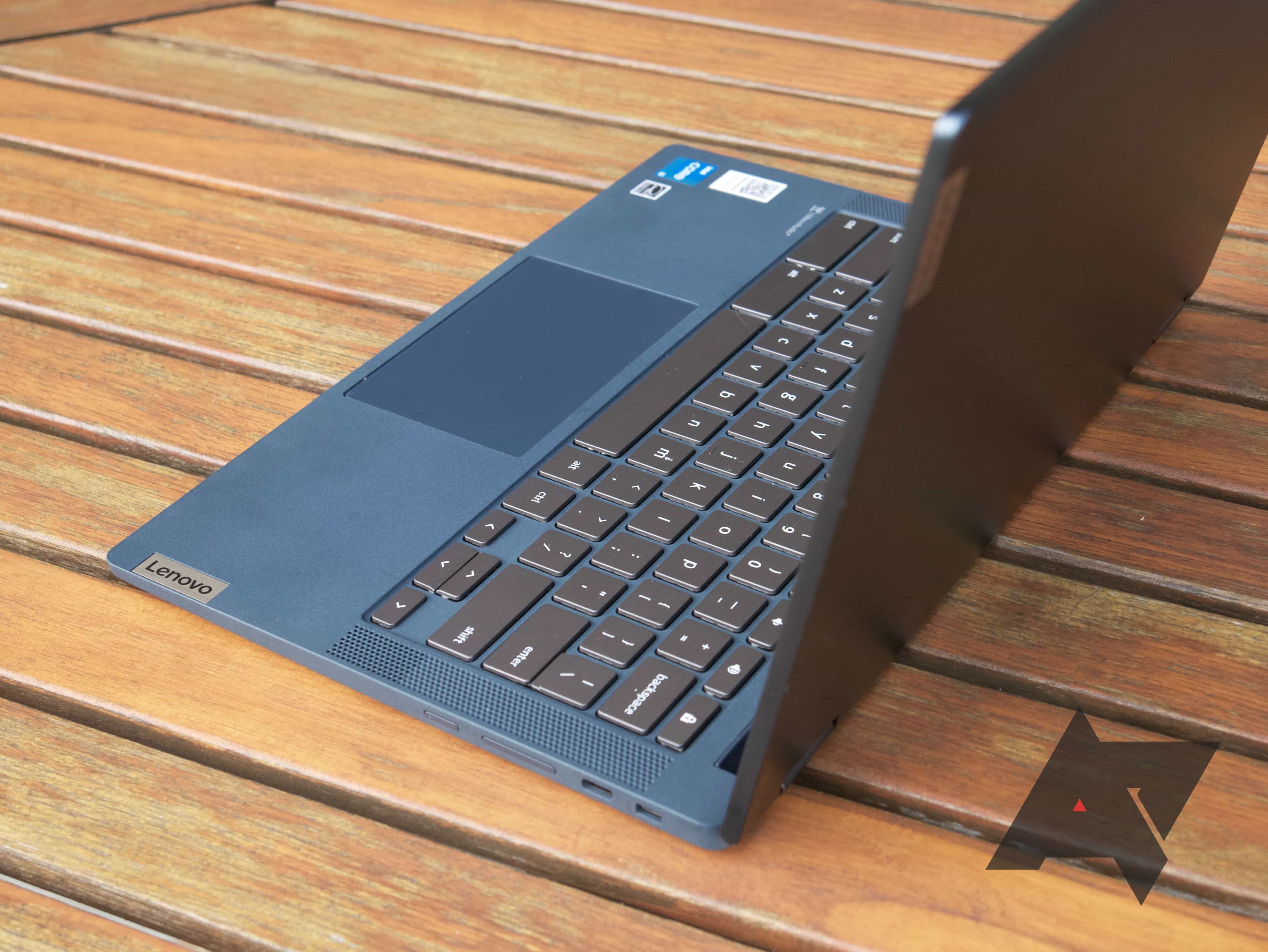 A Lenovo Flex 5 Chromebook sitting sideways on a wooden slatted table