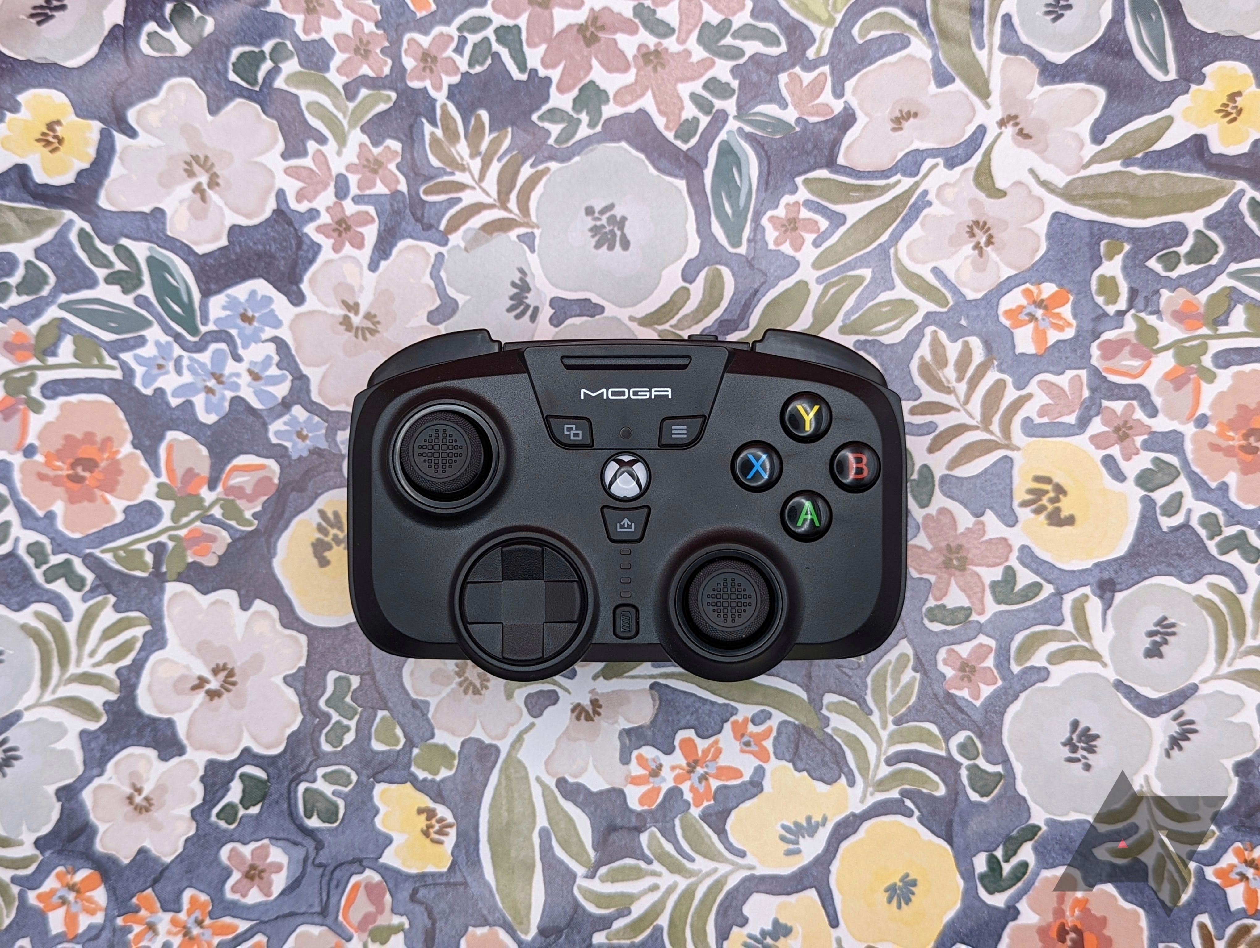 black game controller resting on flowery background
