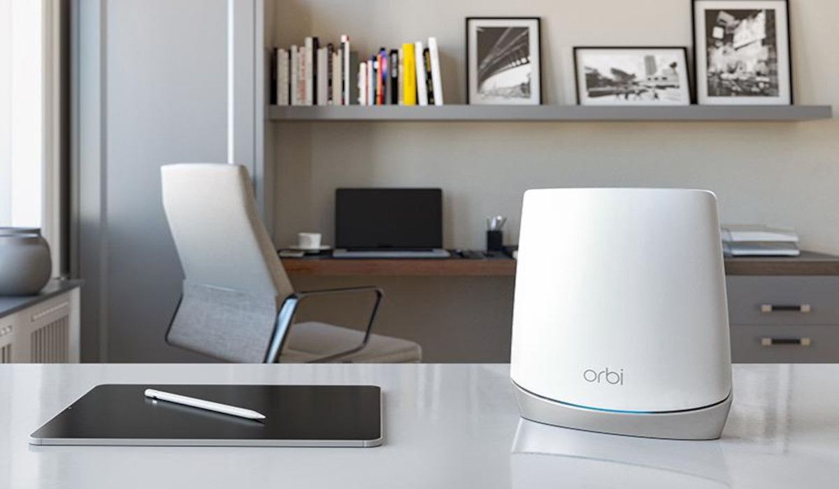 The Netgear Orbi Wi-Fi router sitting on a table in an office