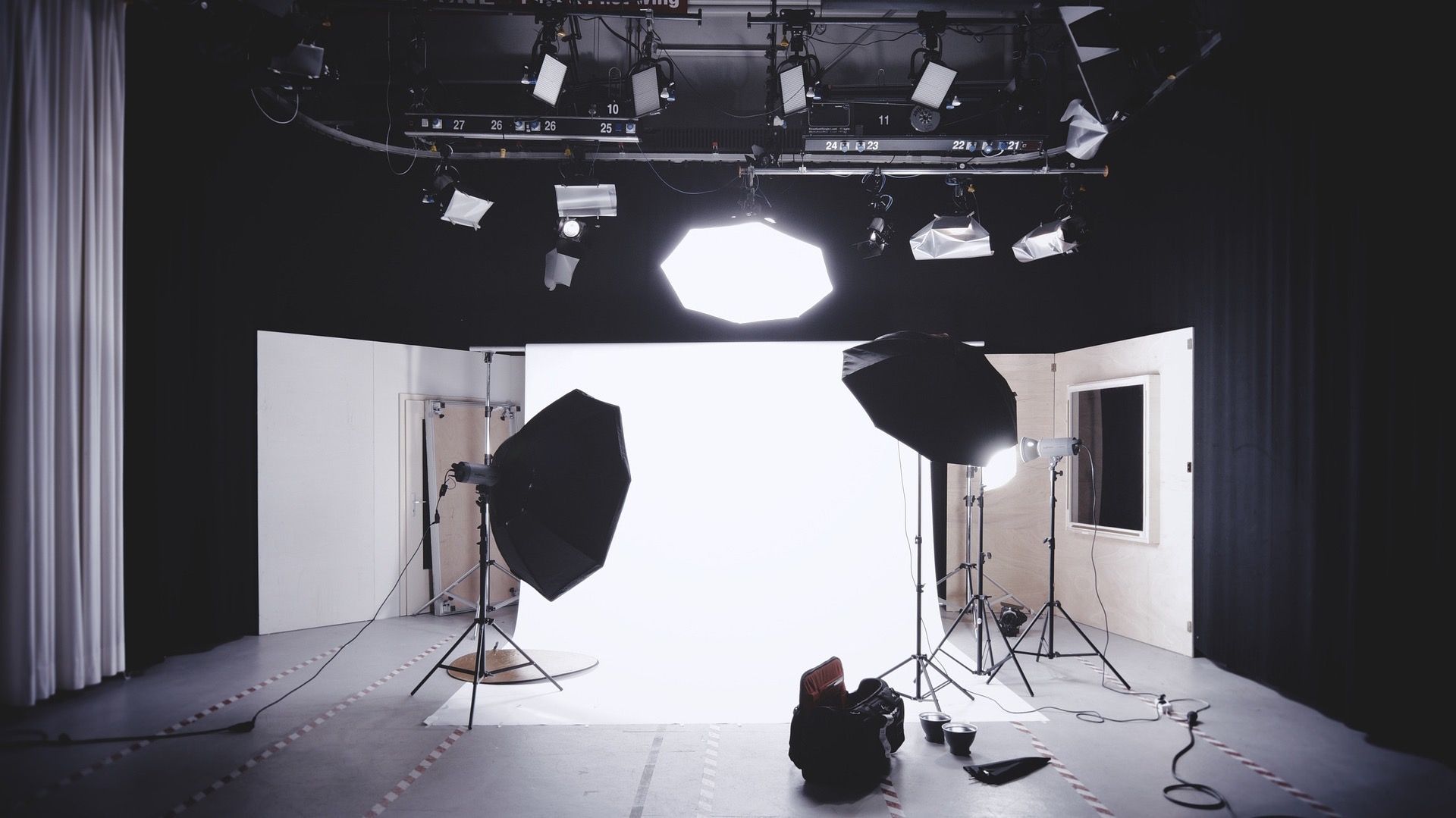 A photo studio with a backdrop and lighting