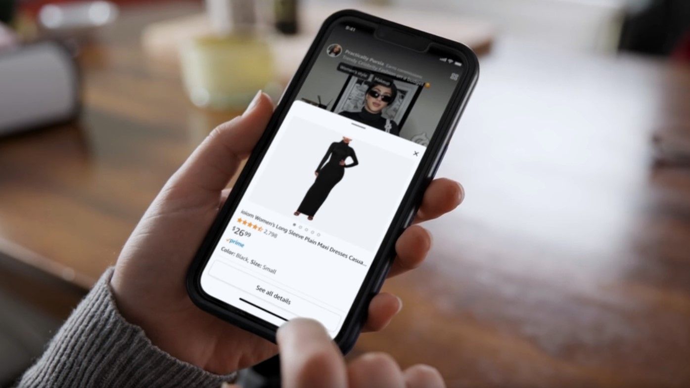 A close image of a person's hands shopping for a dress using the Amazon mobile app.