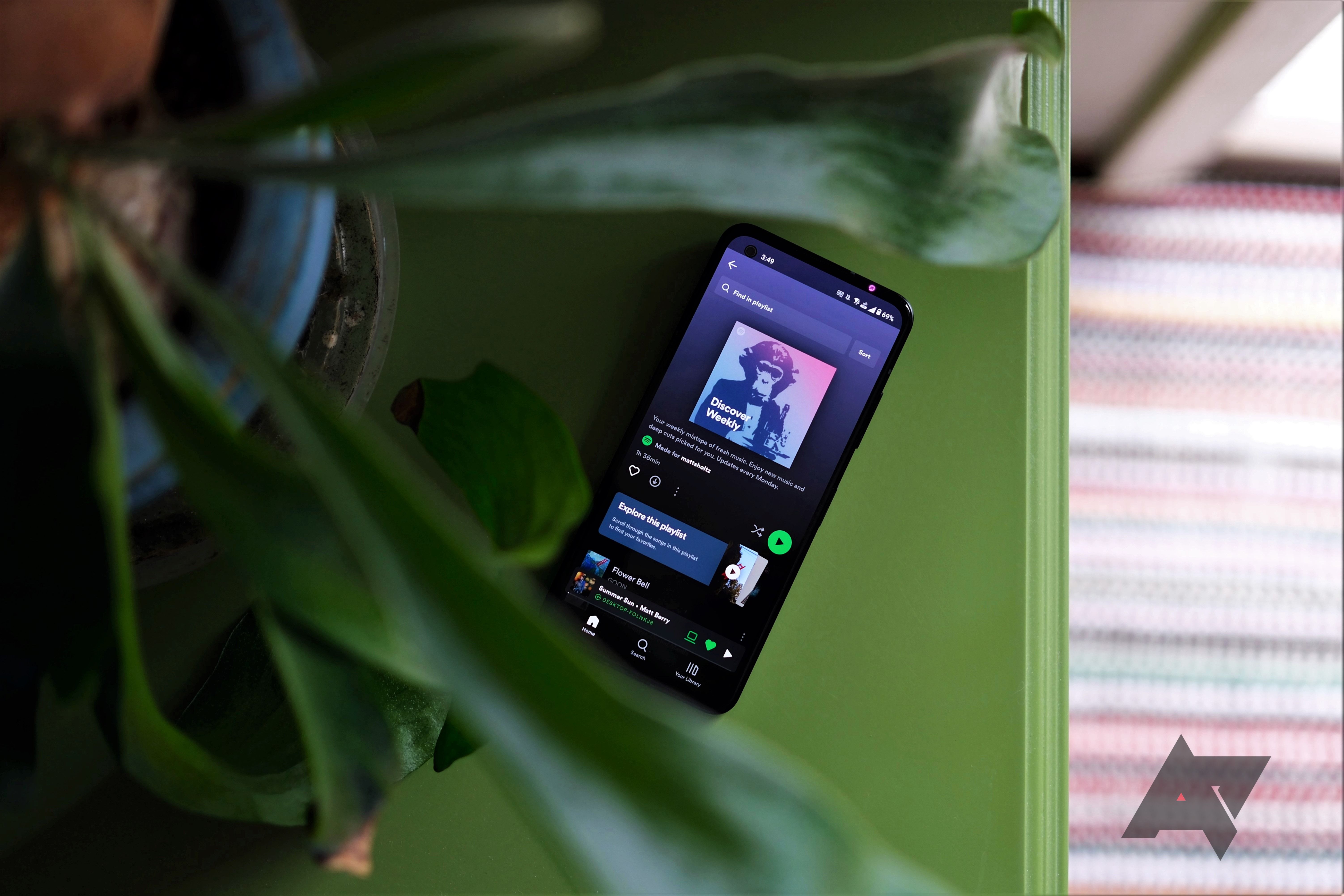 Asus Zenfone 10 playing spotify under plant