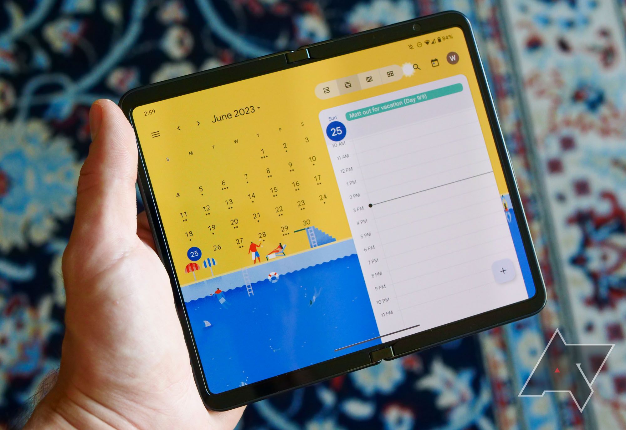 Holding the Pixel Fold in one hand with the calendar app open.