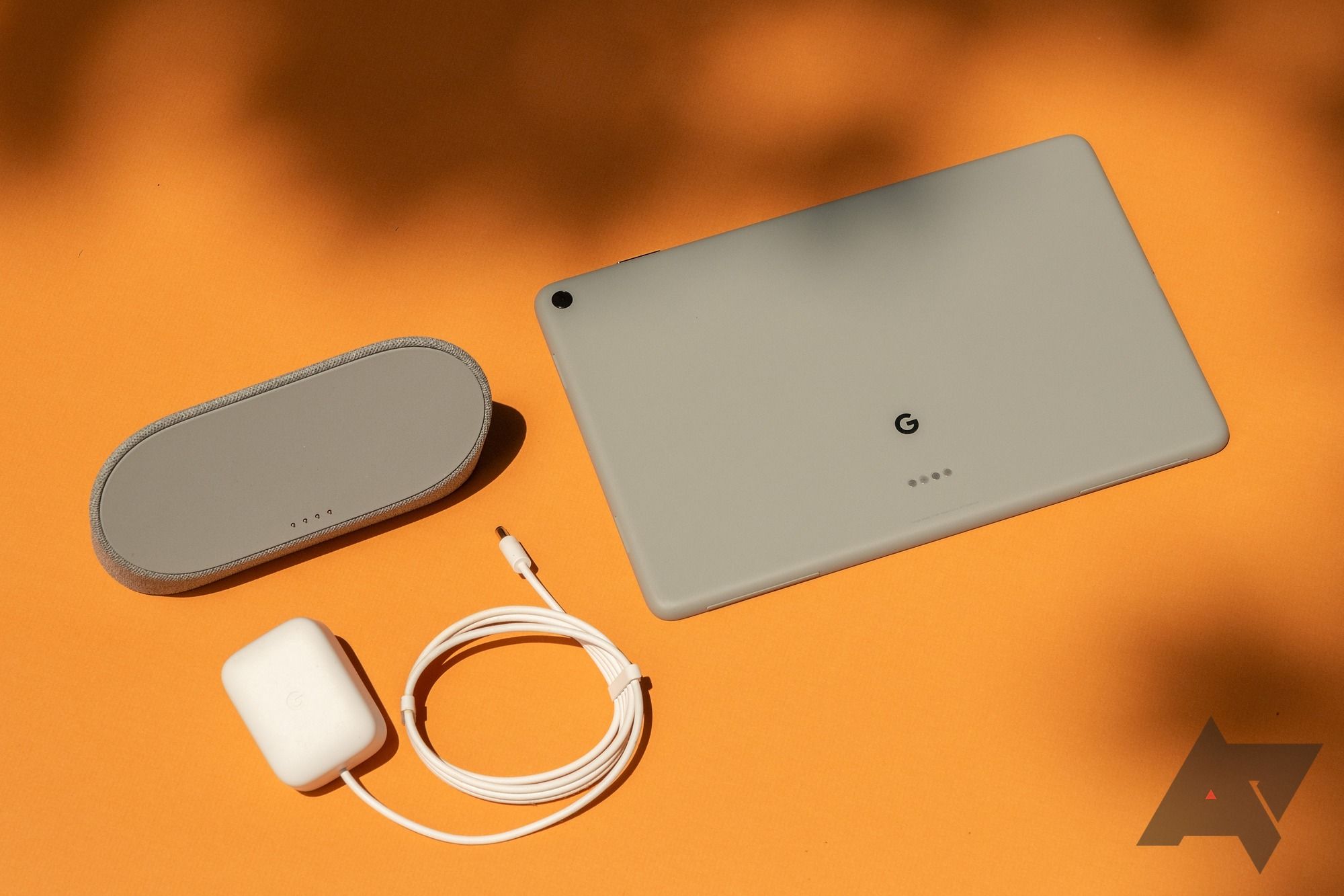 The Google Pixel Tablet, the stand, and the charging cable.