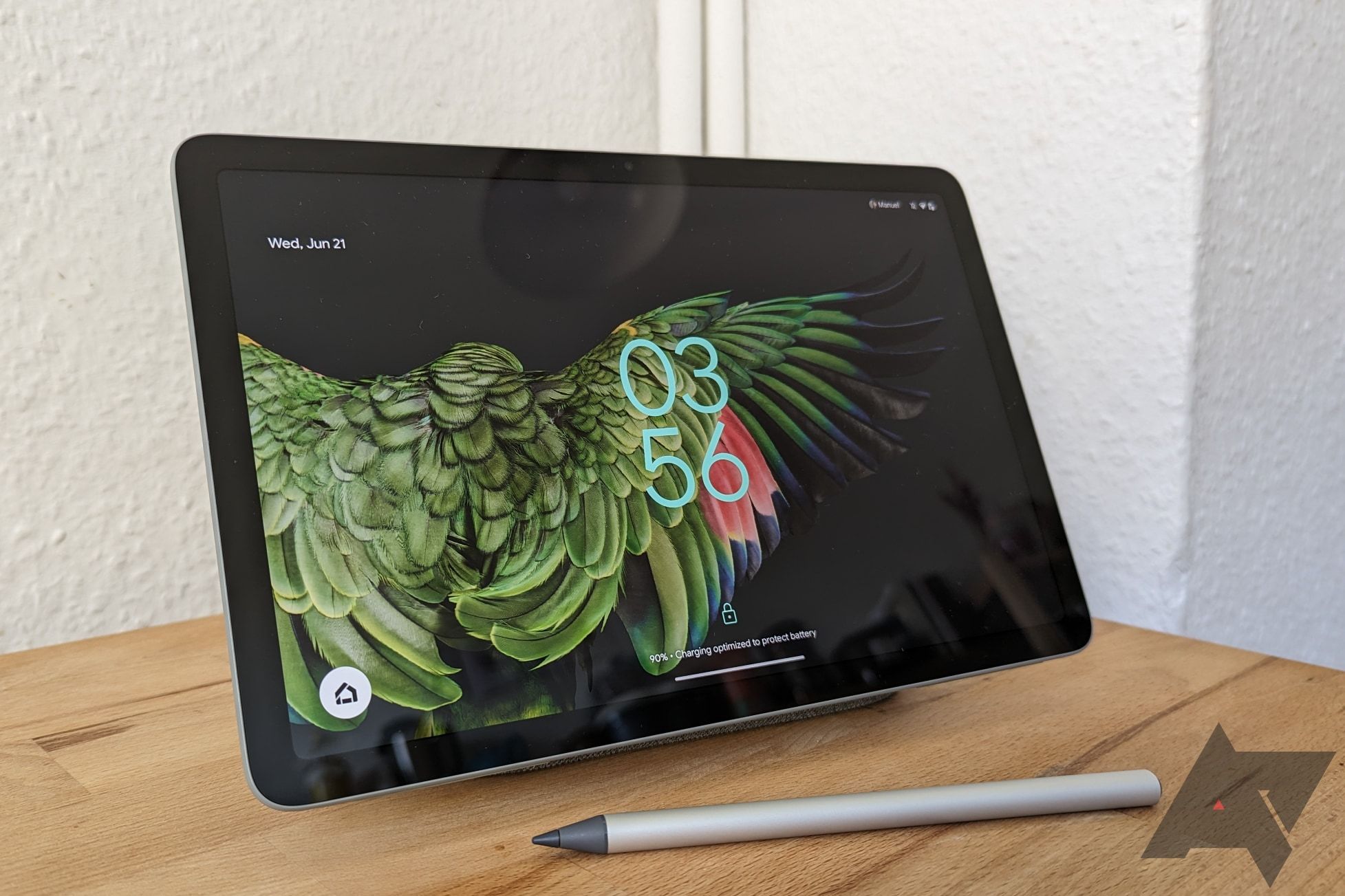 A Google Pixel Tablet with a stylus sitting in front of it
