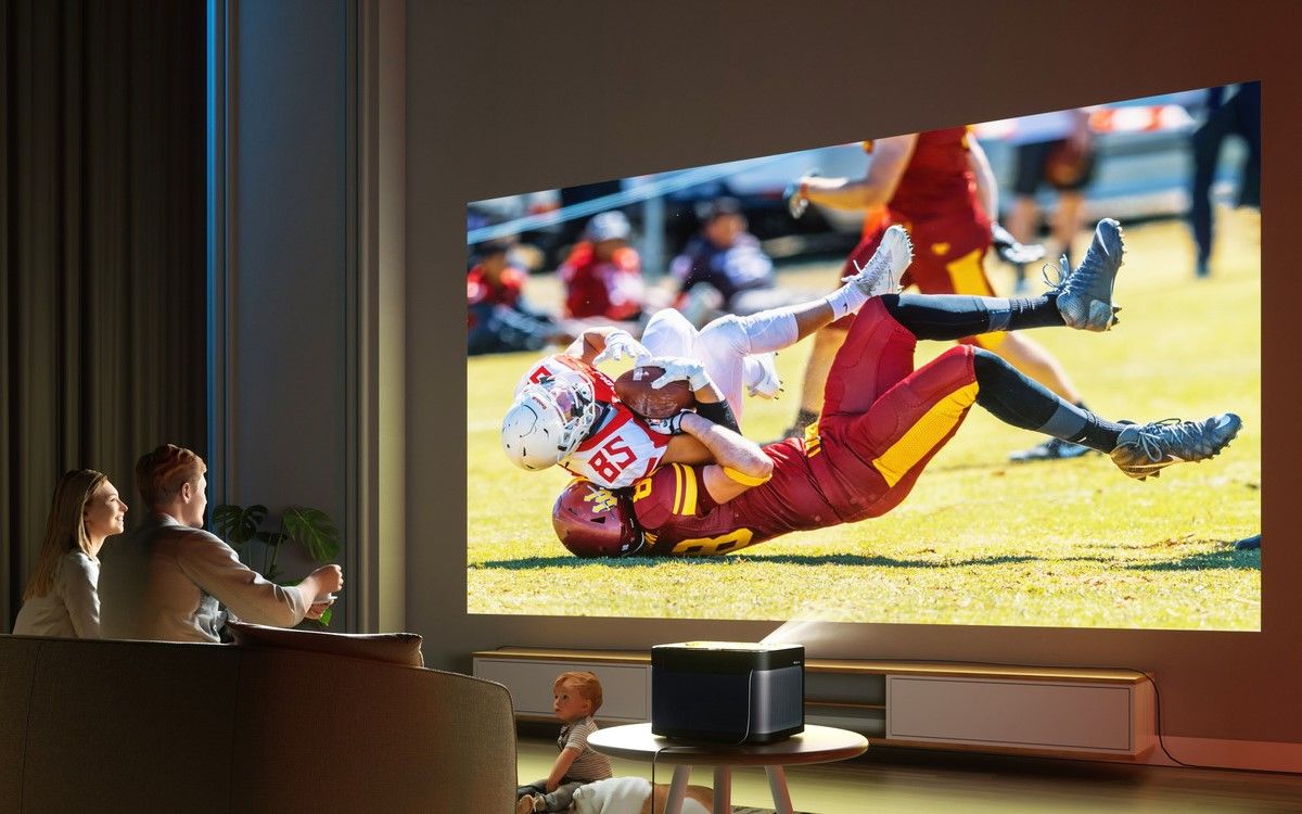 A couple watching a football match with Dangbei Mars Pro projector