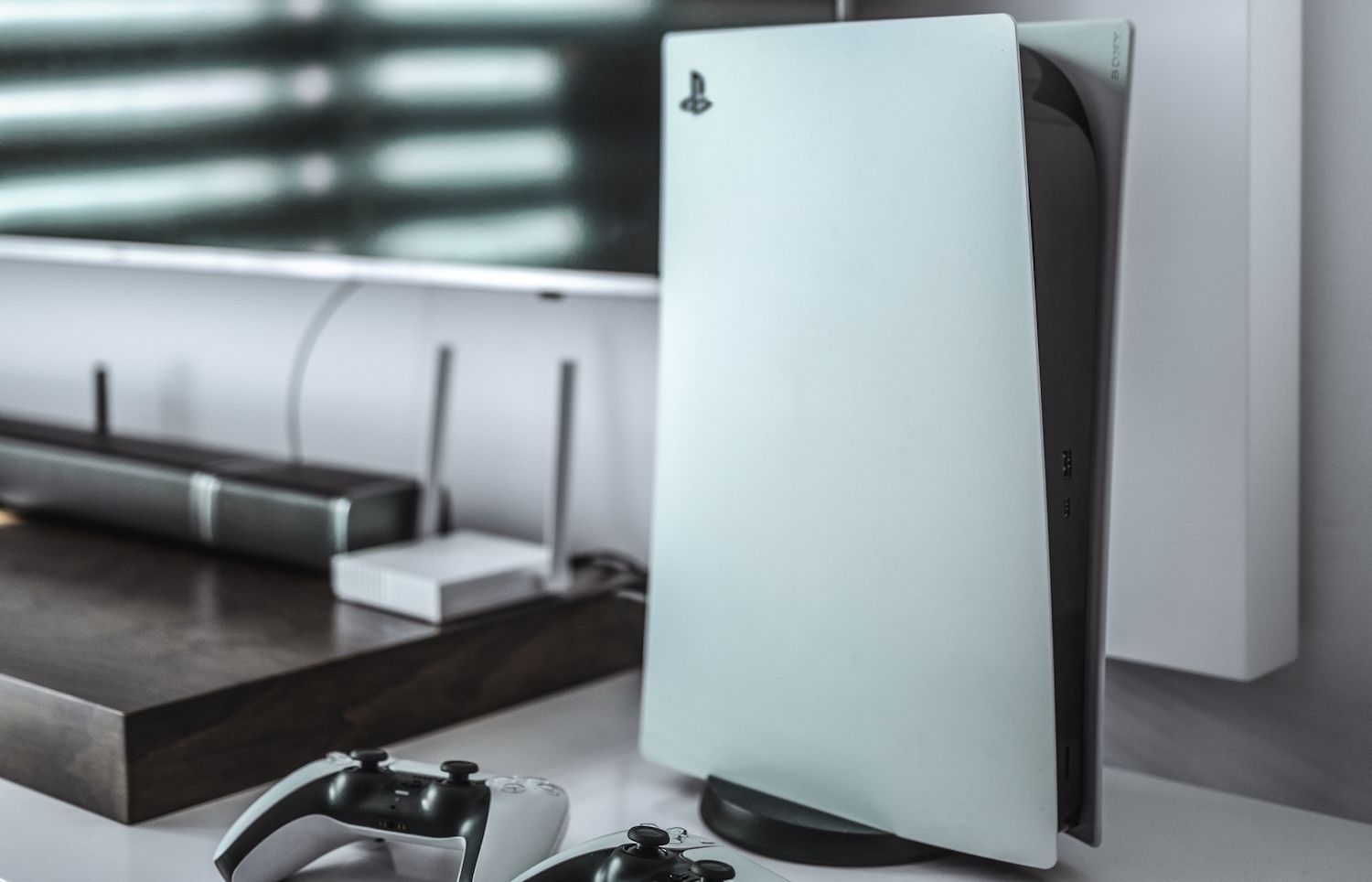 PlayStation 5 and controller stationed on counter space with white interior