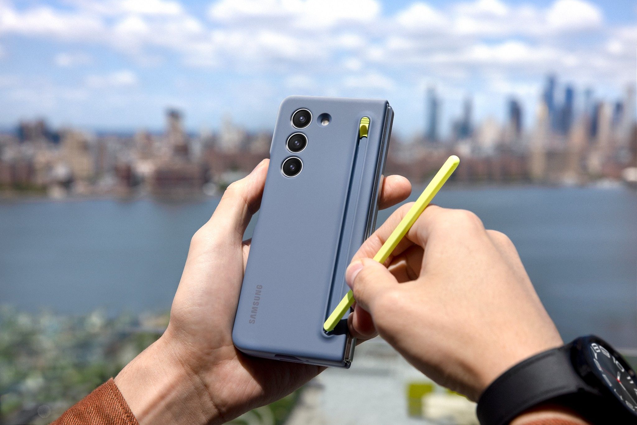 Samsung Galaxy Z Fold 5 held in hand with the yellow S Pen