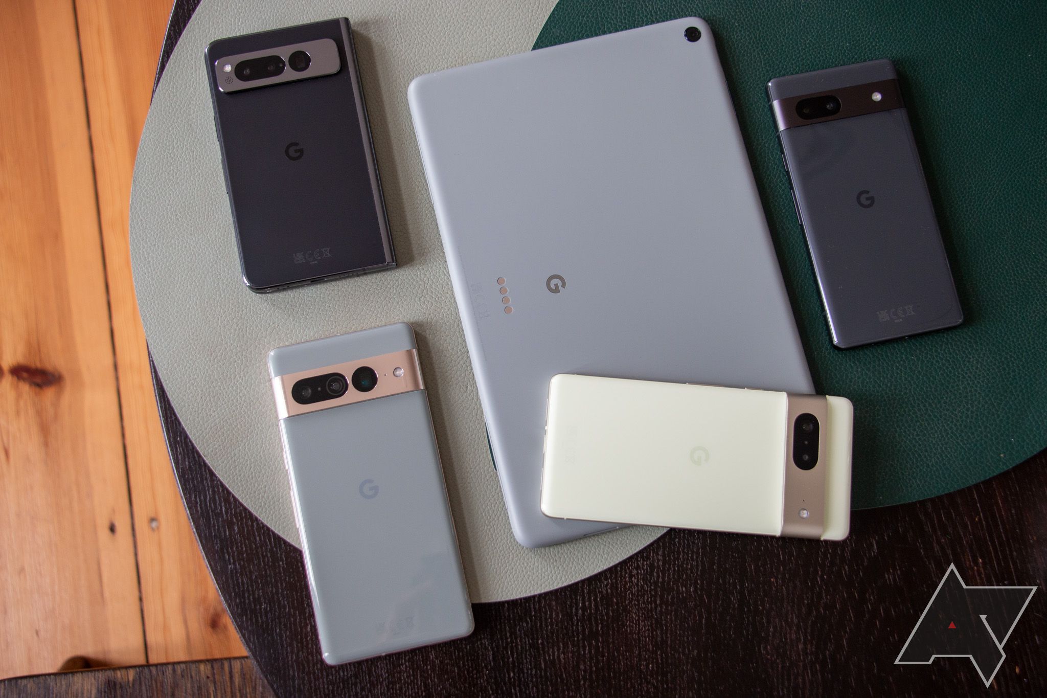 Displaying the Google Pixel Tablet, Google Pixel Fold, and other recent Google Pixel smartphones on a table