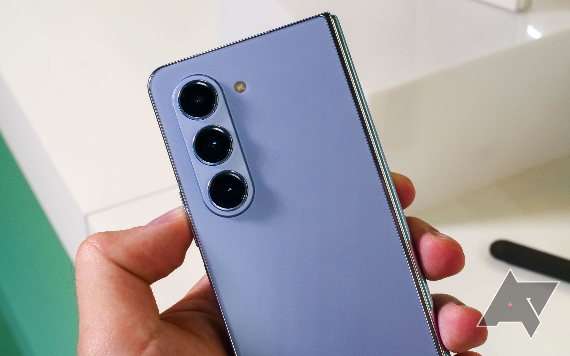 Blue Samsung Galaxy Z Fold 5 is held to show camera array