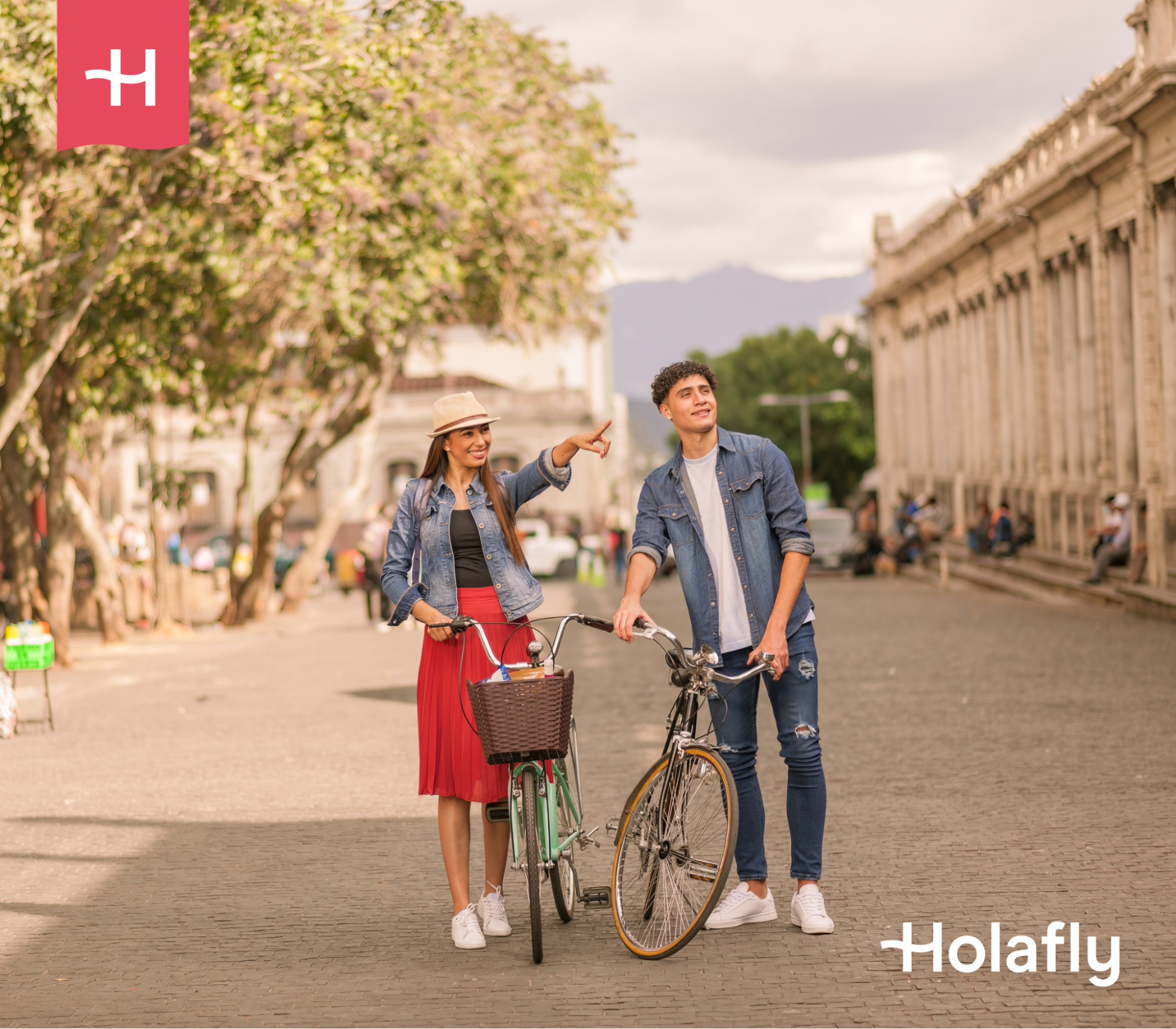 A couple walks thru streets in Europe with their bikes