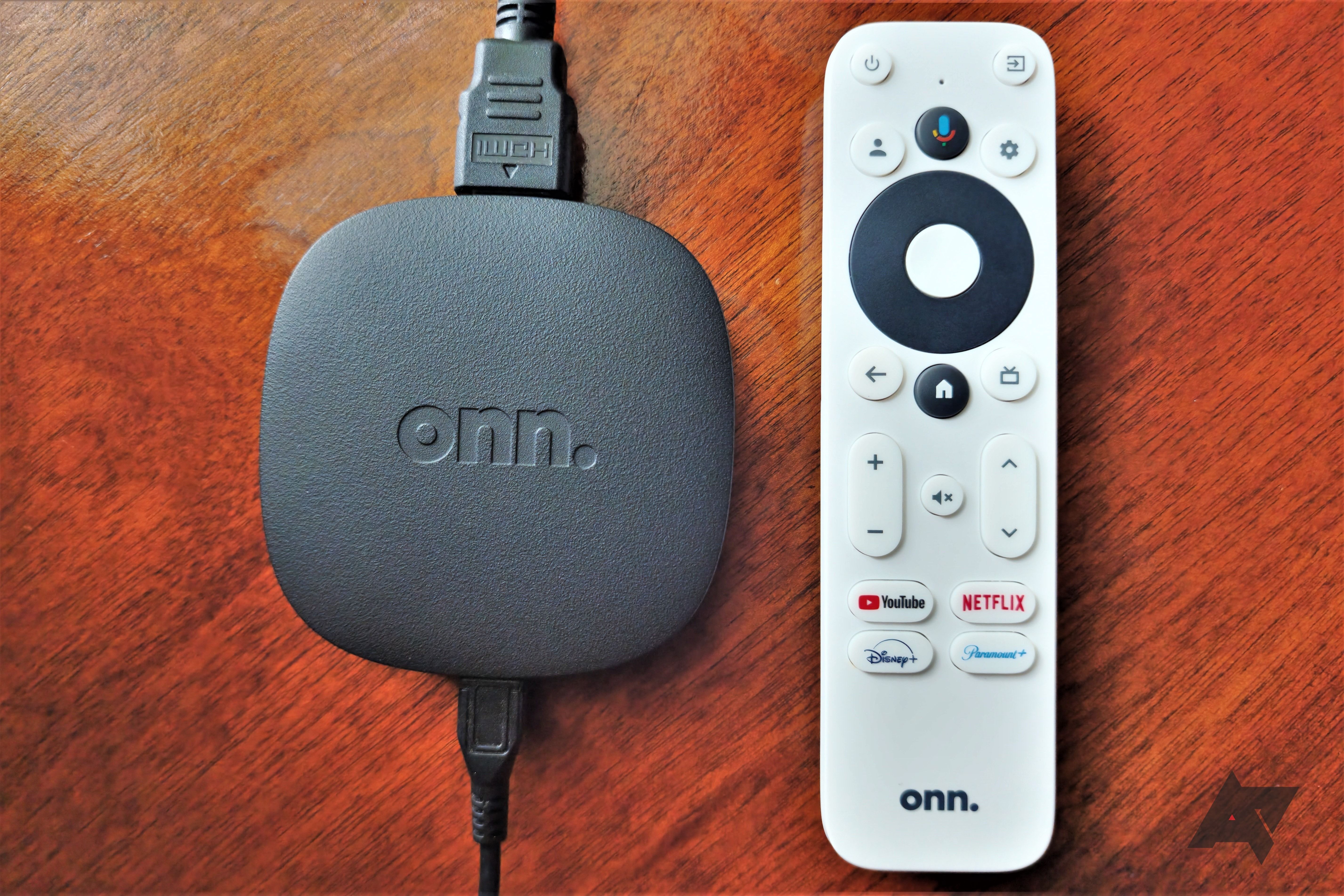 Onn Google TV 4K Streaming Box laying face up in wood table
