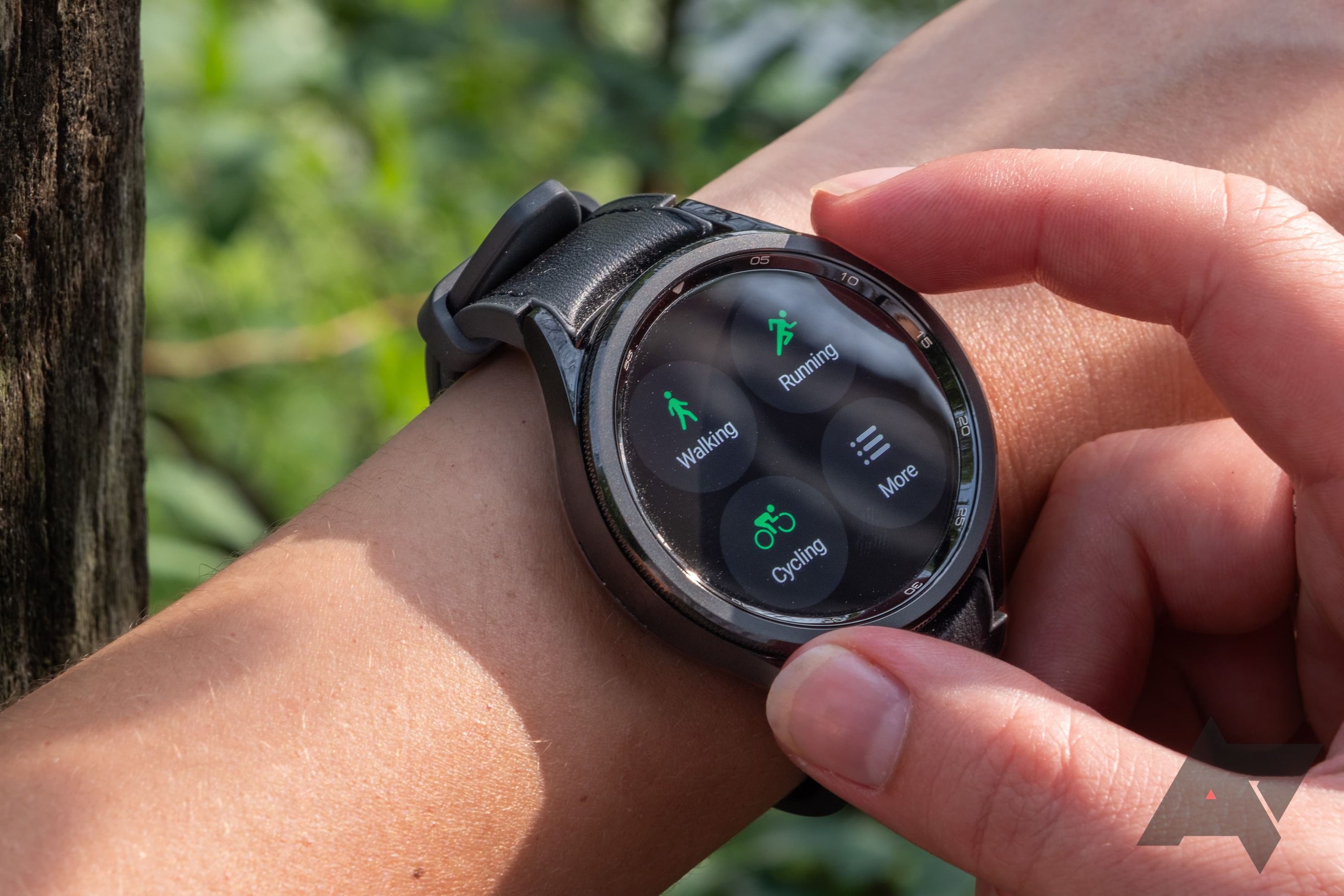 A smartwatch on a wrist, showing exercise tracking options. 