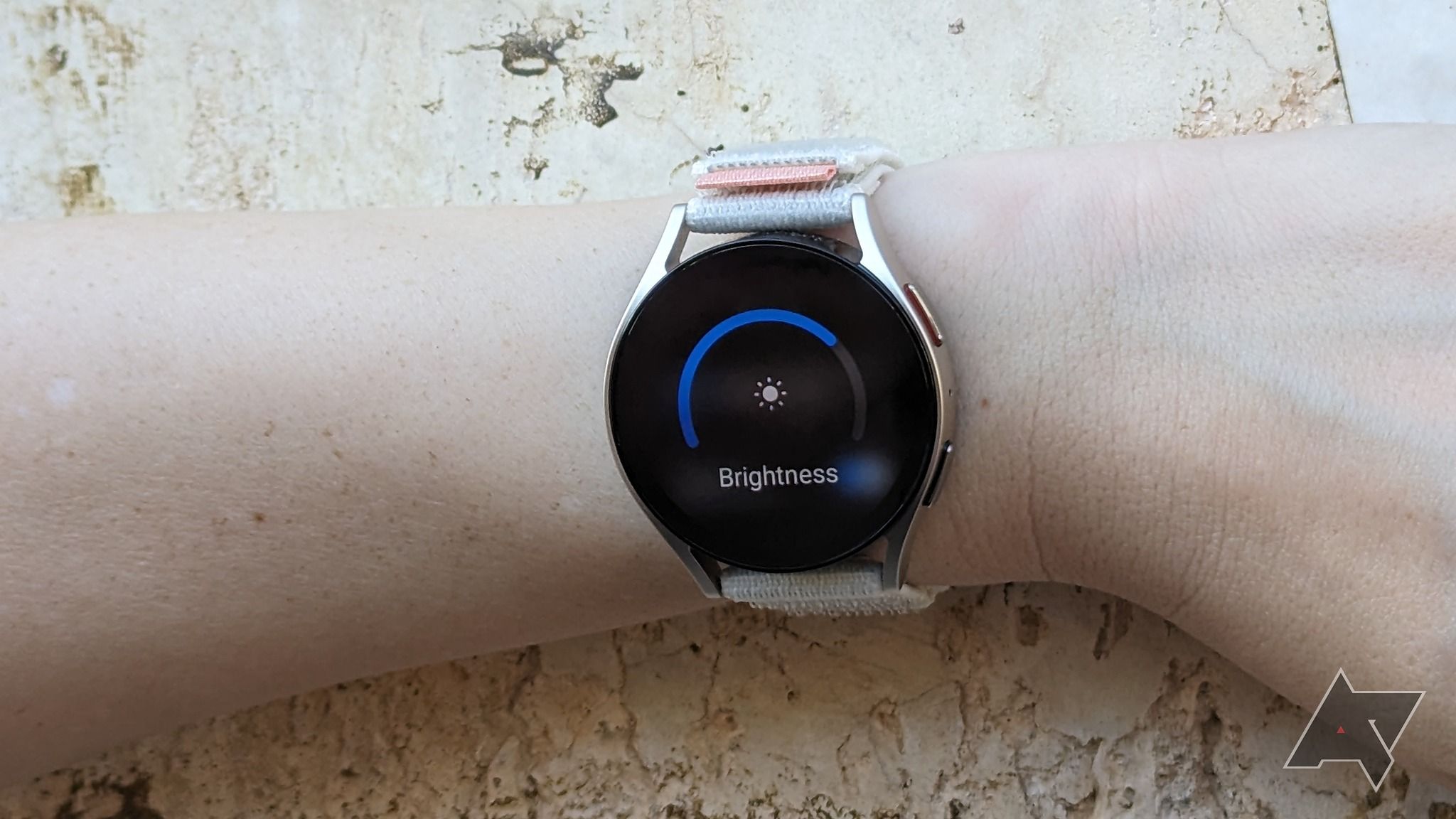 A smartwatch displaying Brightness settings