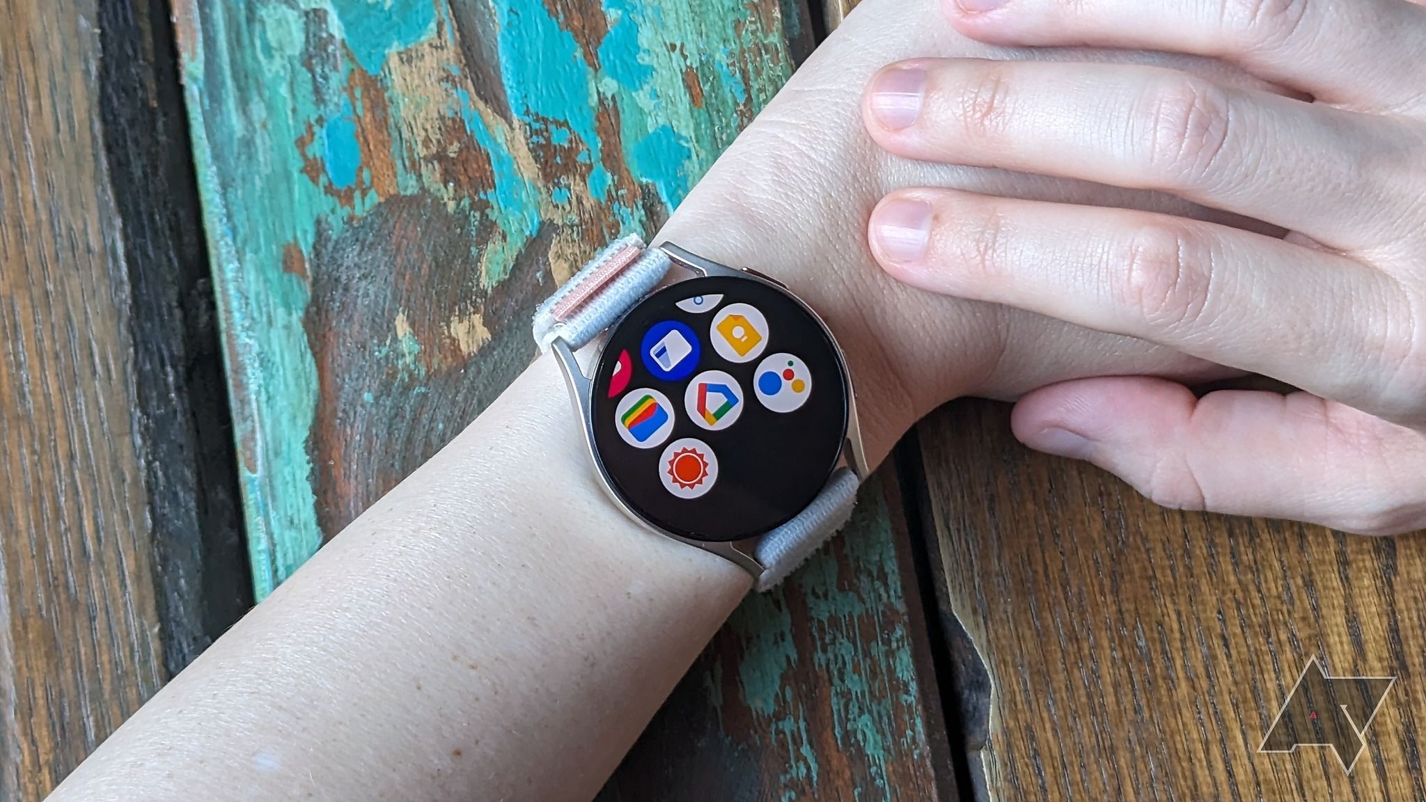 A Samsung Galaxy Watch 6 on a person's wrist looking through installed apps