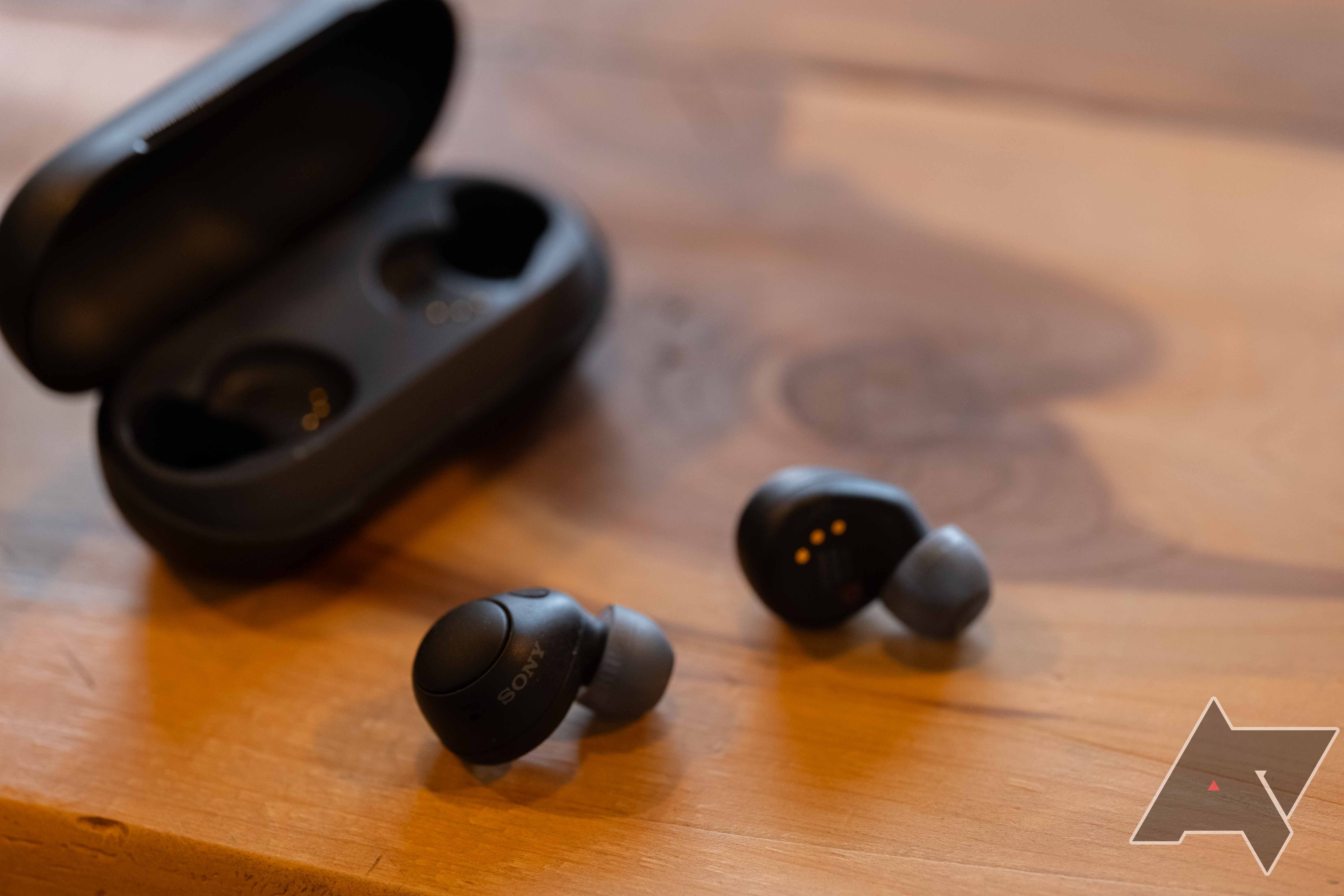 the Sony WF-C700N earbuds on a table in front of the open charging case