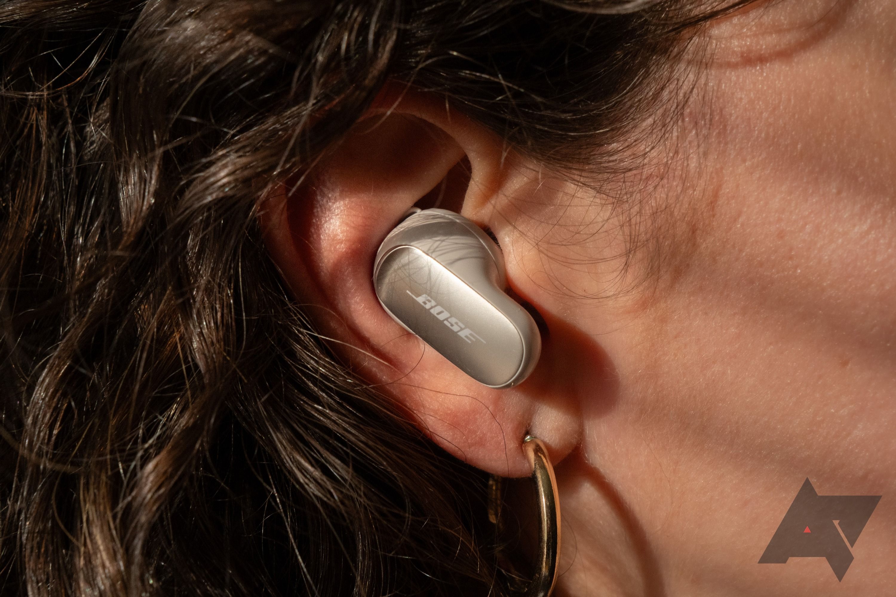 Close-up image of Bose QuietComfort Ultra earbuds comfortably positioned in a user's ear, showcasing their sleek design and fit.