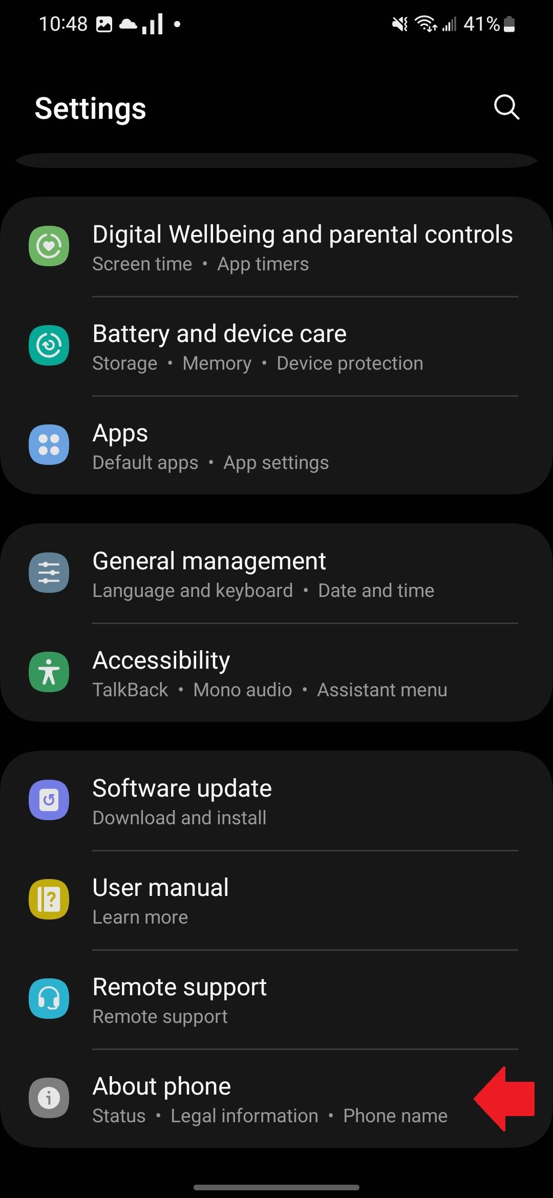 The Samsung Settings app with a red arrow pointing to the About phone section