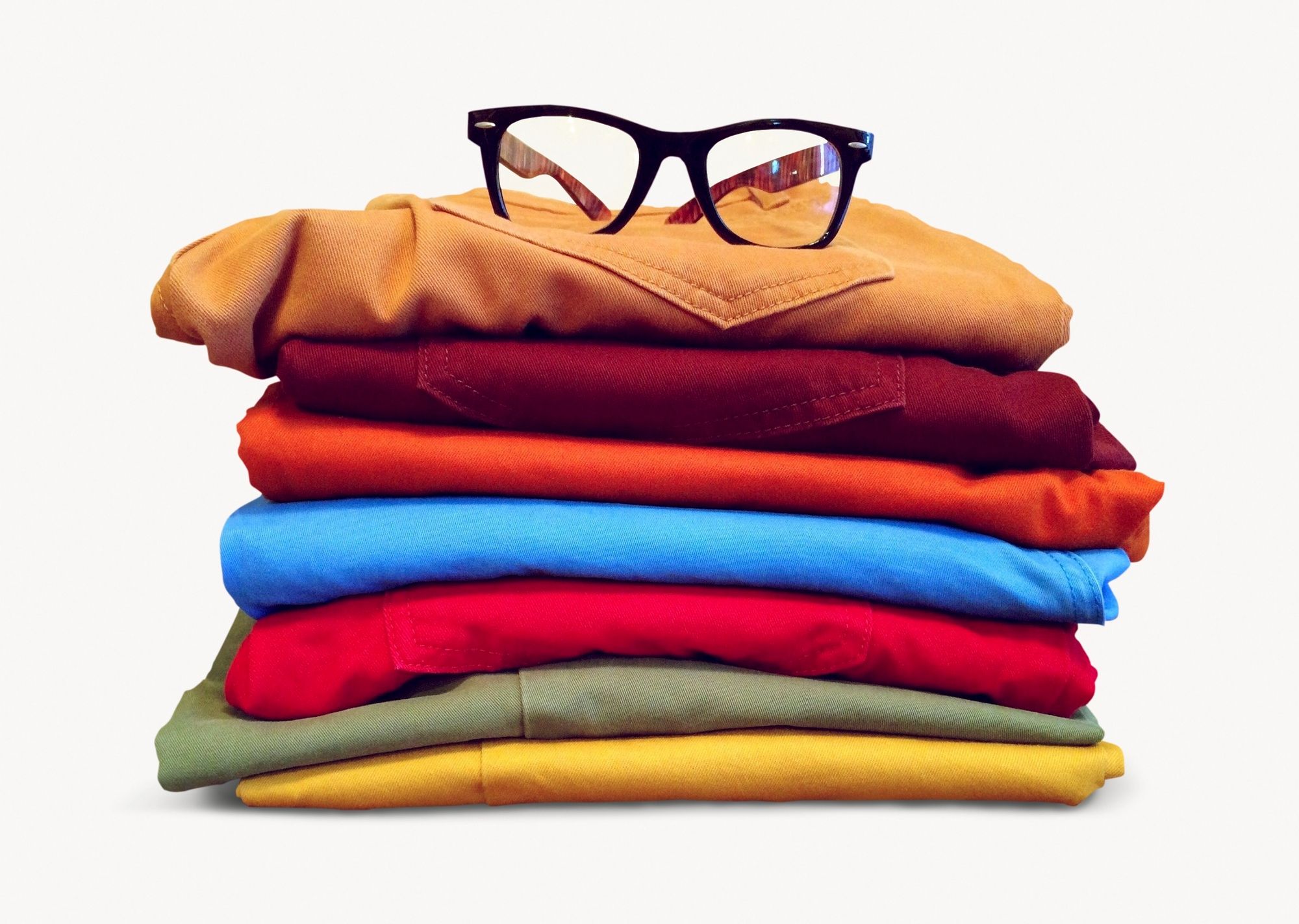 A pile of clothes with glasses on top