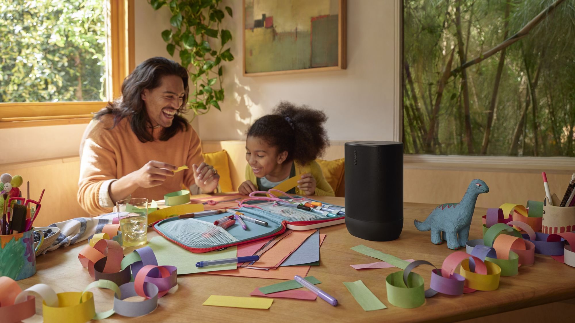 Parent and child crafting at house with sad Sonos Depart 2 on table.