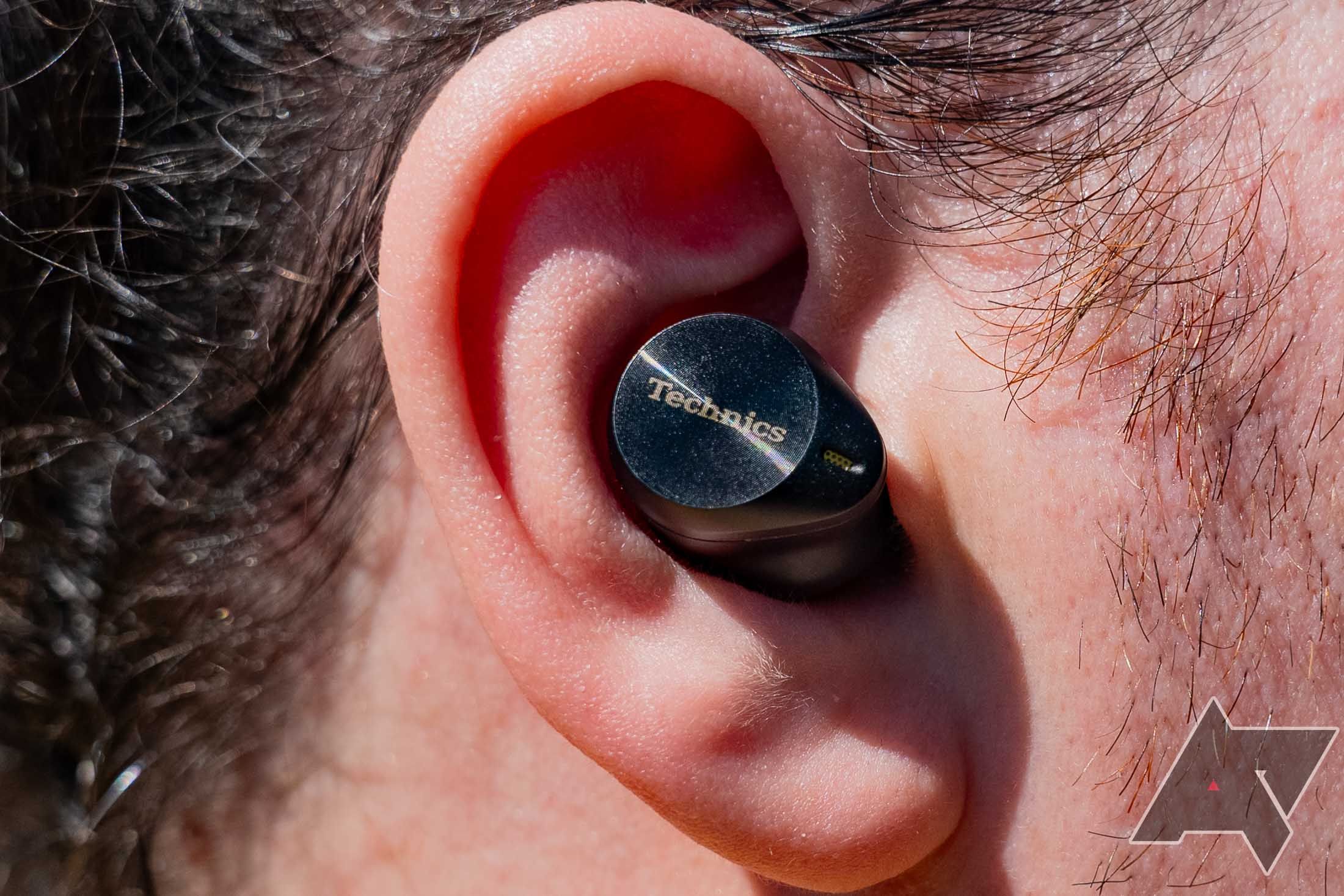 Head-on view of an AZ80 but in an ear, showing off the subtle swirl on the touch targets that's reminiscent of the groove of a record