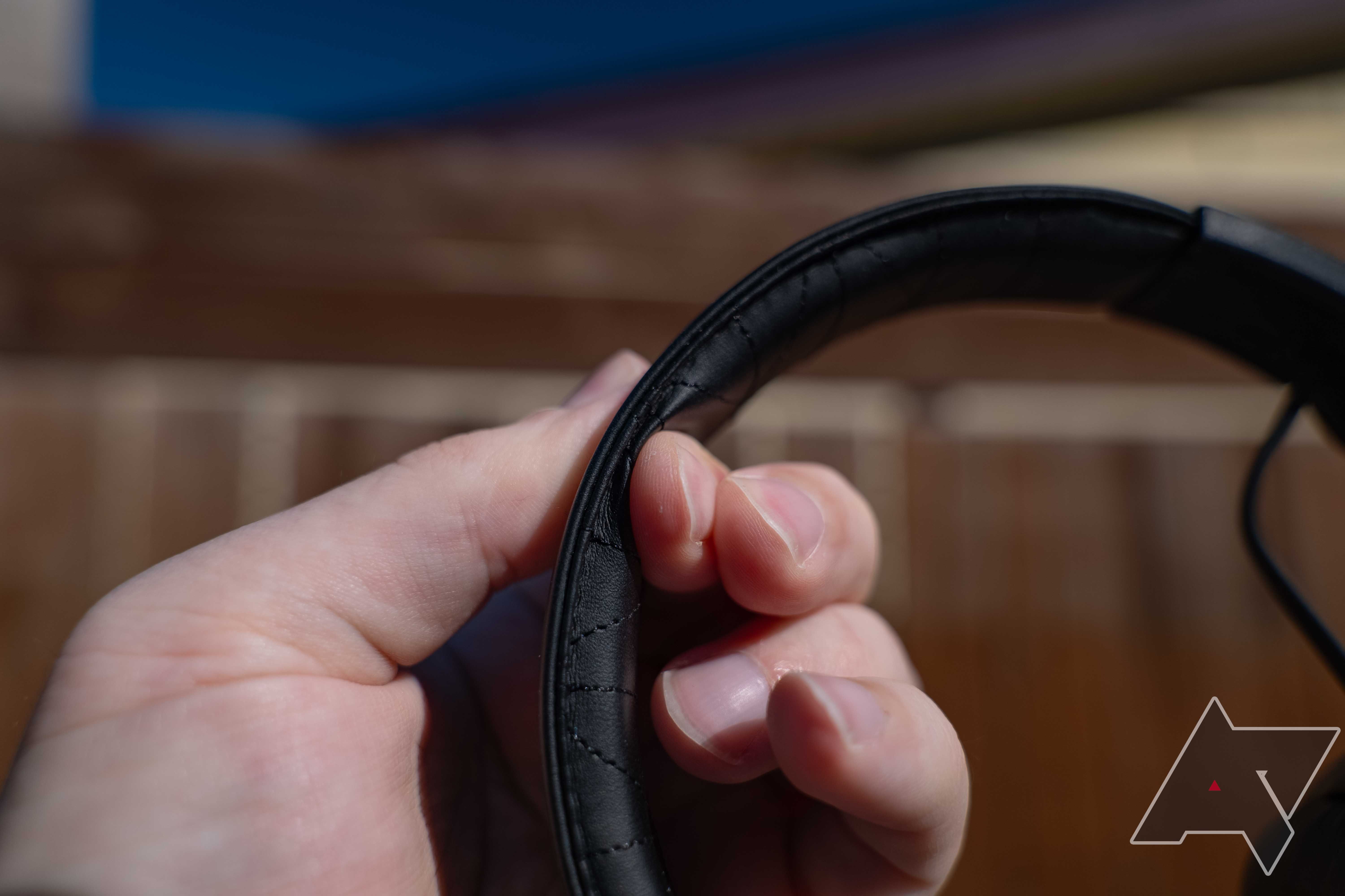 squishing the thin headband cushion of the JLab Studio Pro ANC