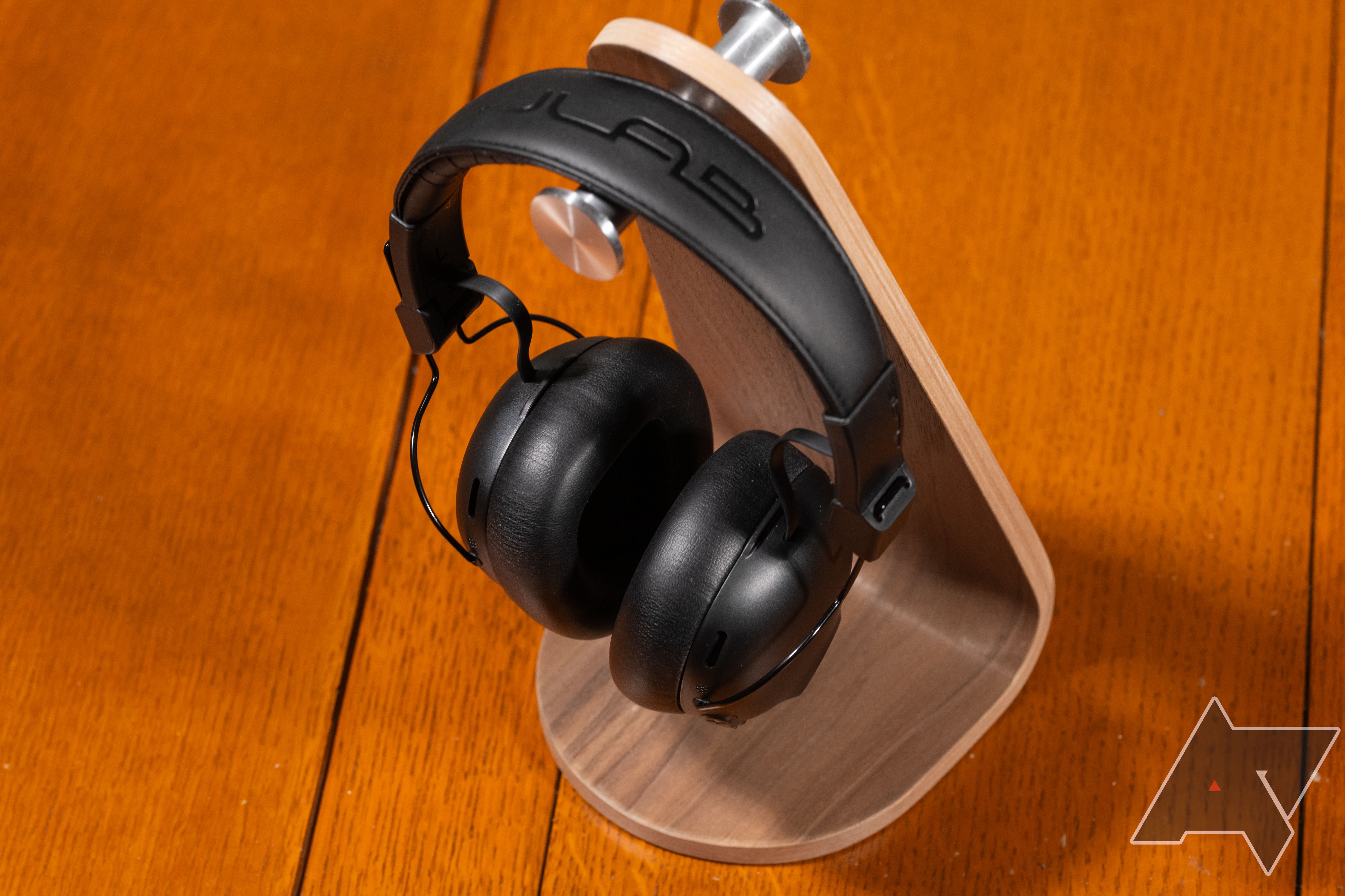The JLab Studio Pro ANC headphones on a headphone stand