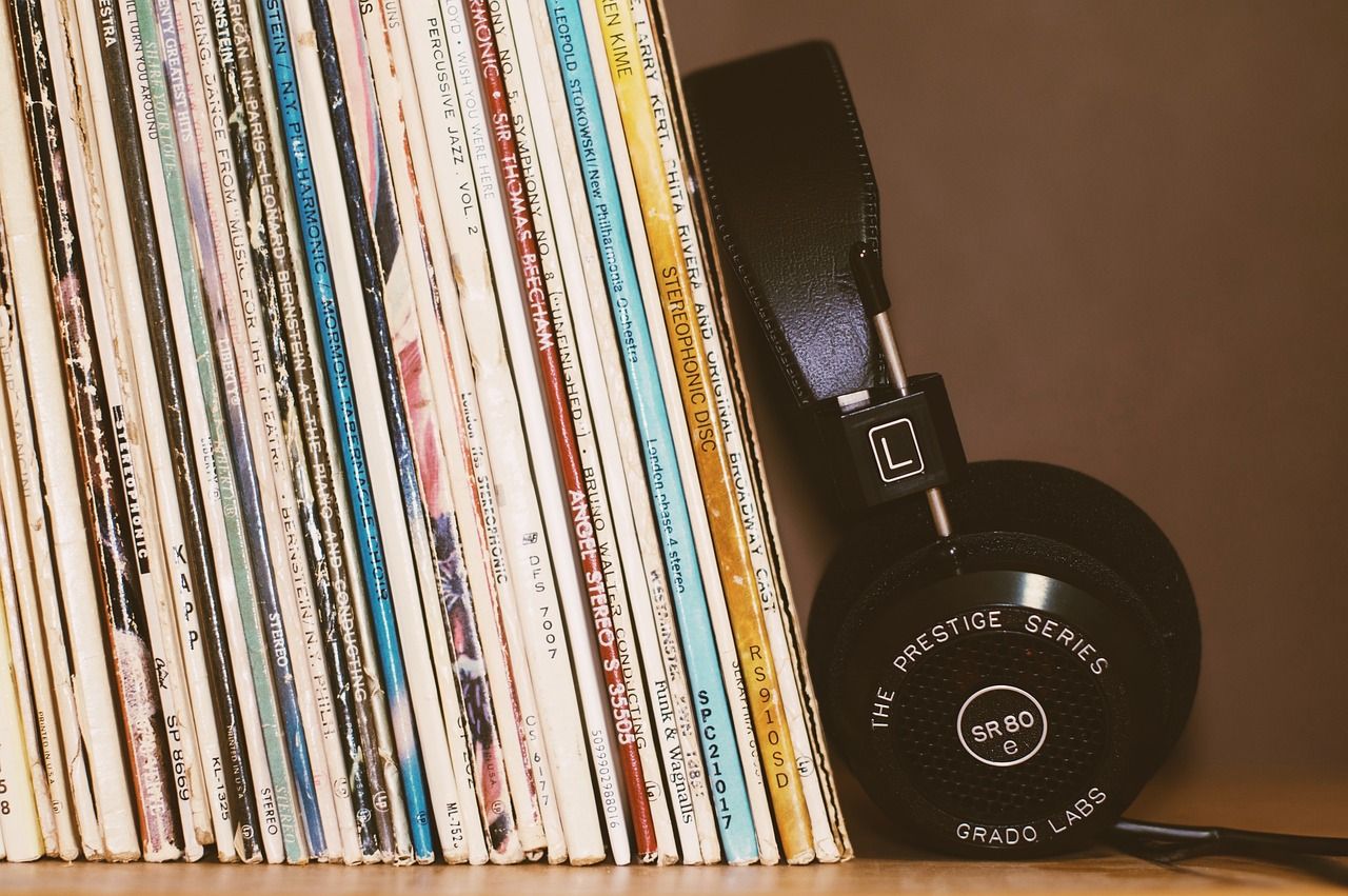 Stacked music discs and headphones.