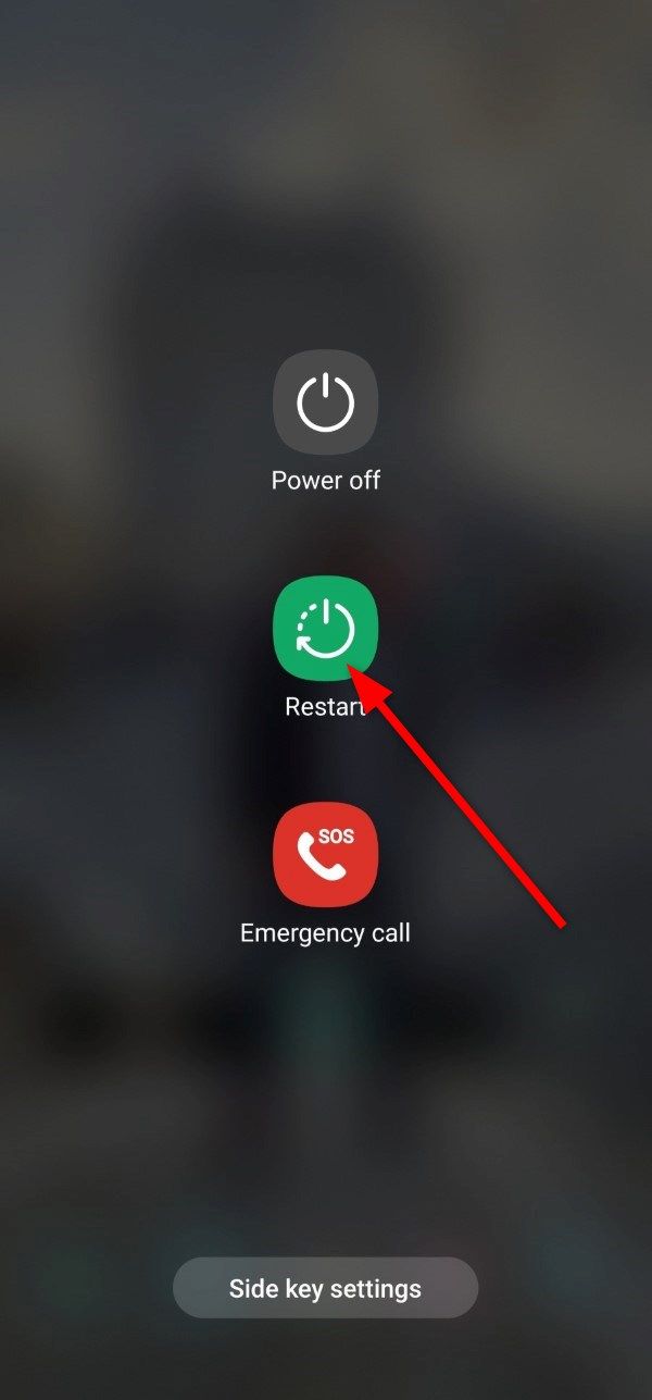Samsung Galaxy phone power menu with an arrow pointing to the Restart button