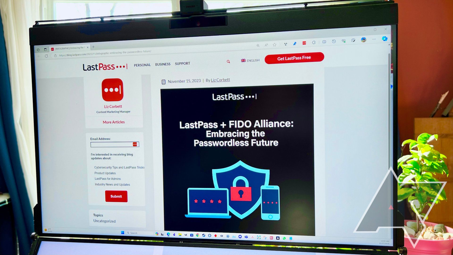 A computer screen in front of a glowing window shows a LastPass. blog post about the Fido Alliance.