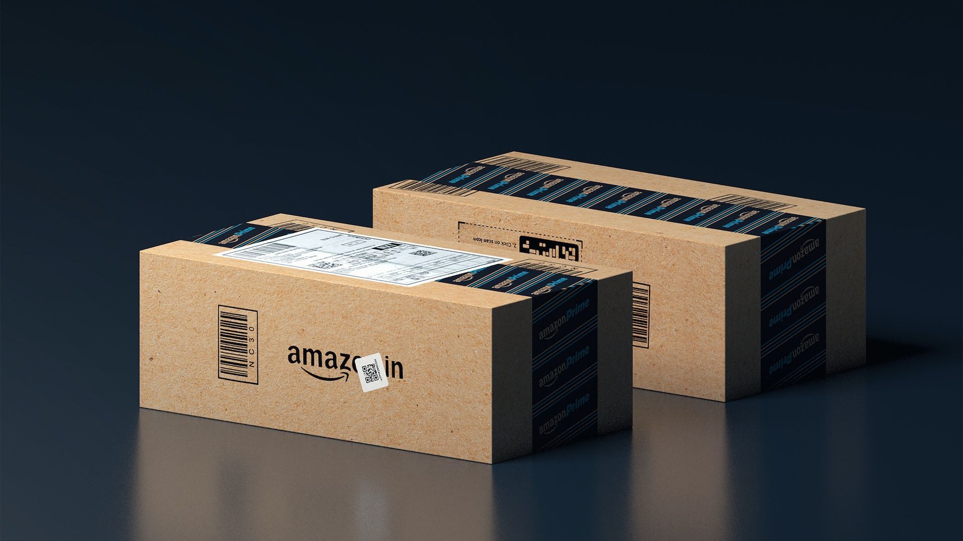 Two Amazon boxes sit on a blue surface. 