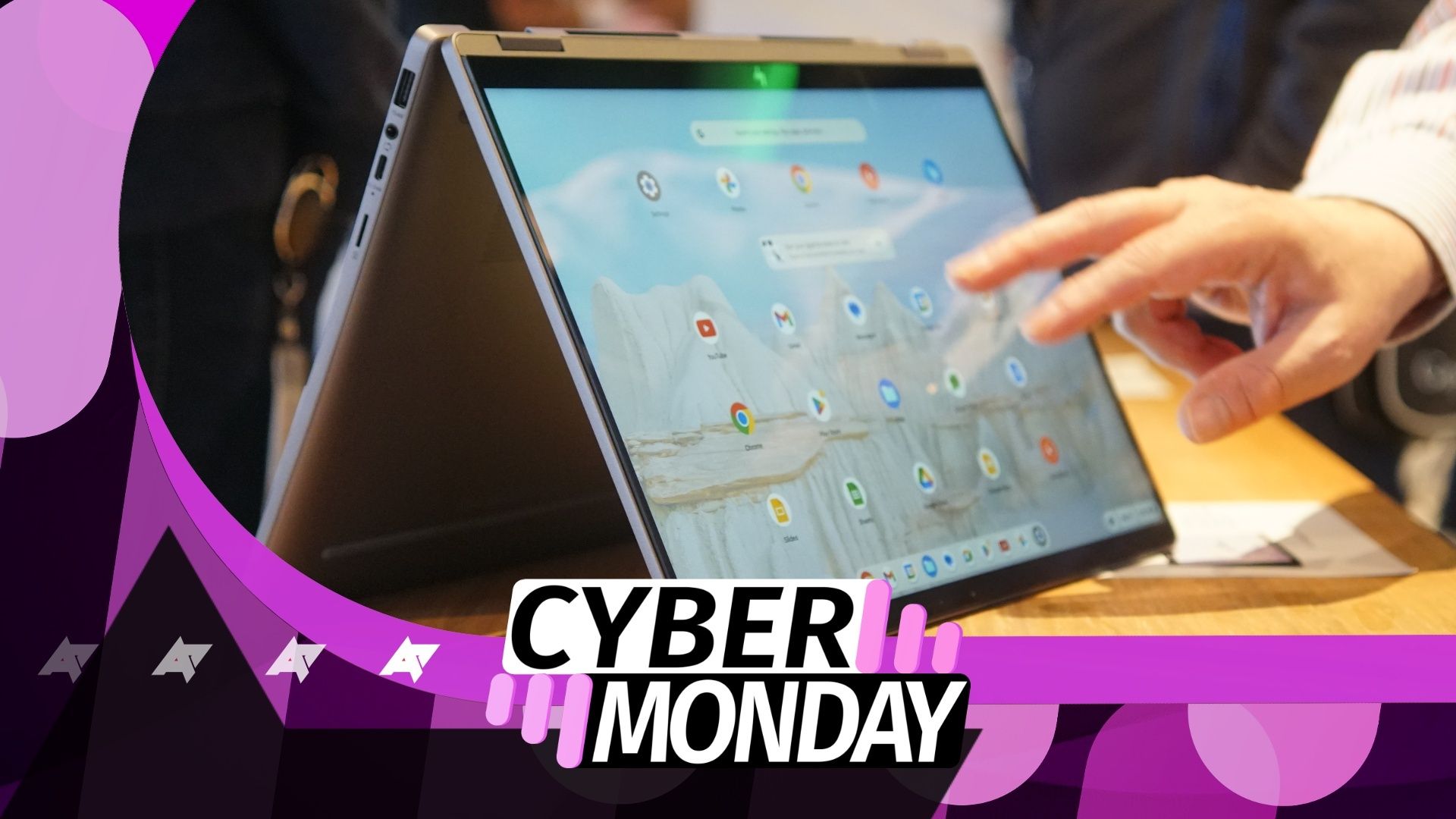 A photo of a Chromebook flipped open with a Cyber Monday banner logo overlaid