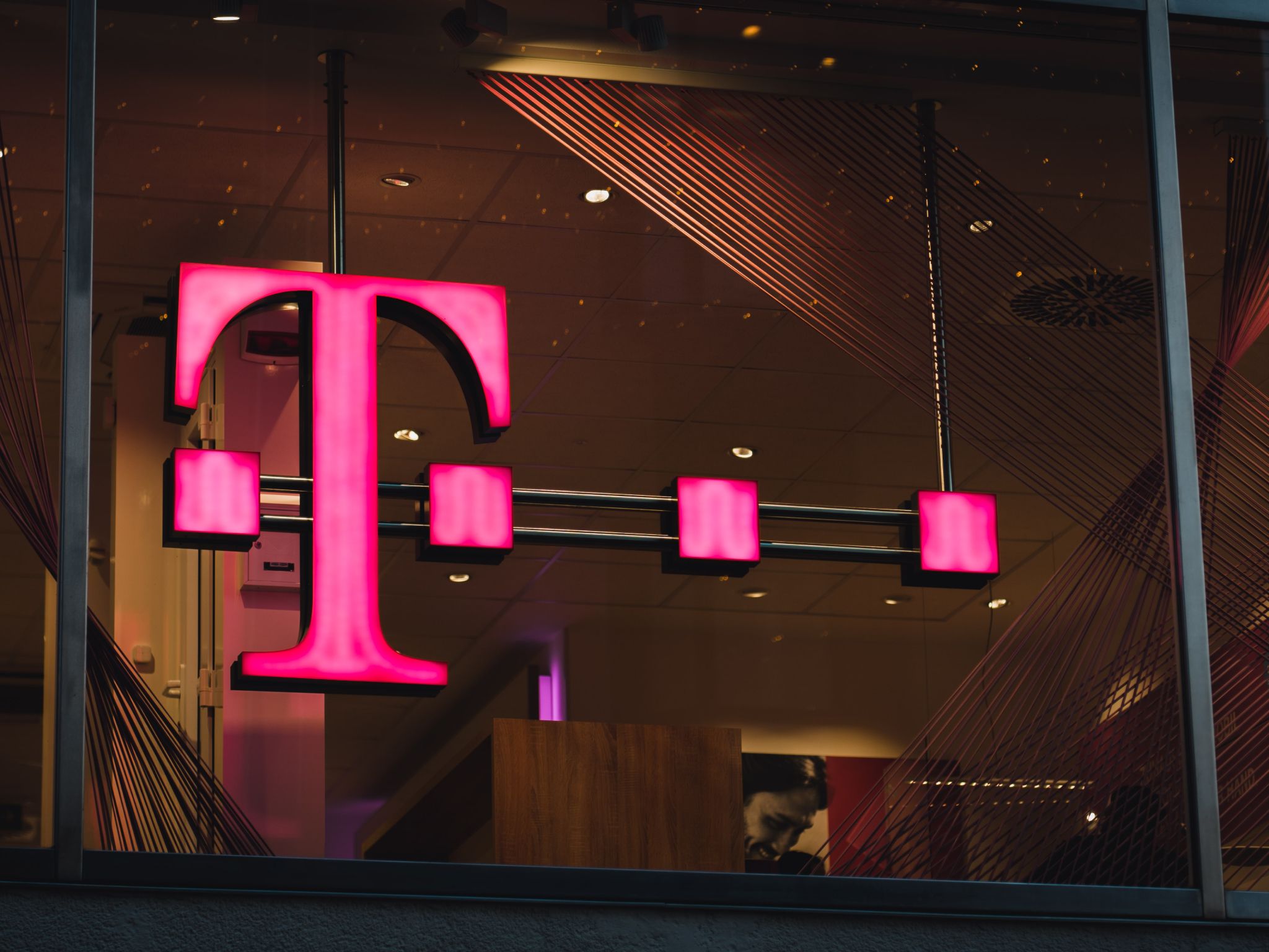 T-Mobile sign hanging in an office building.
