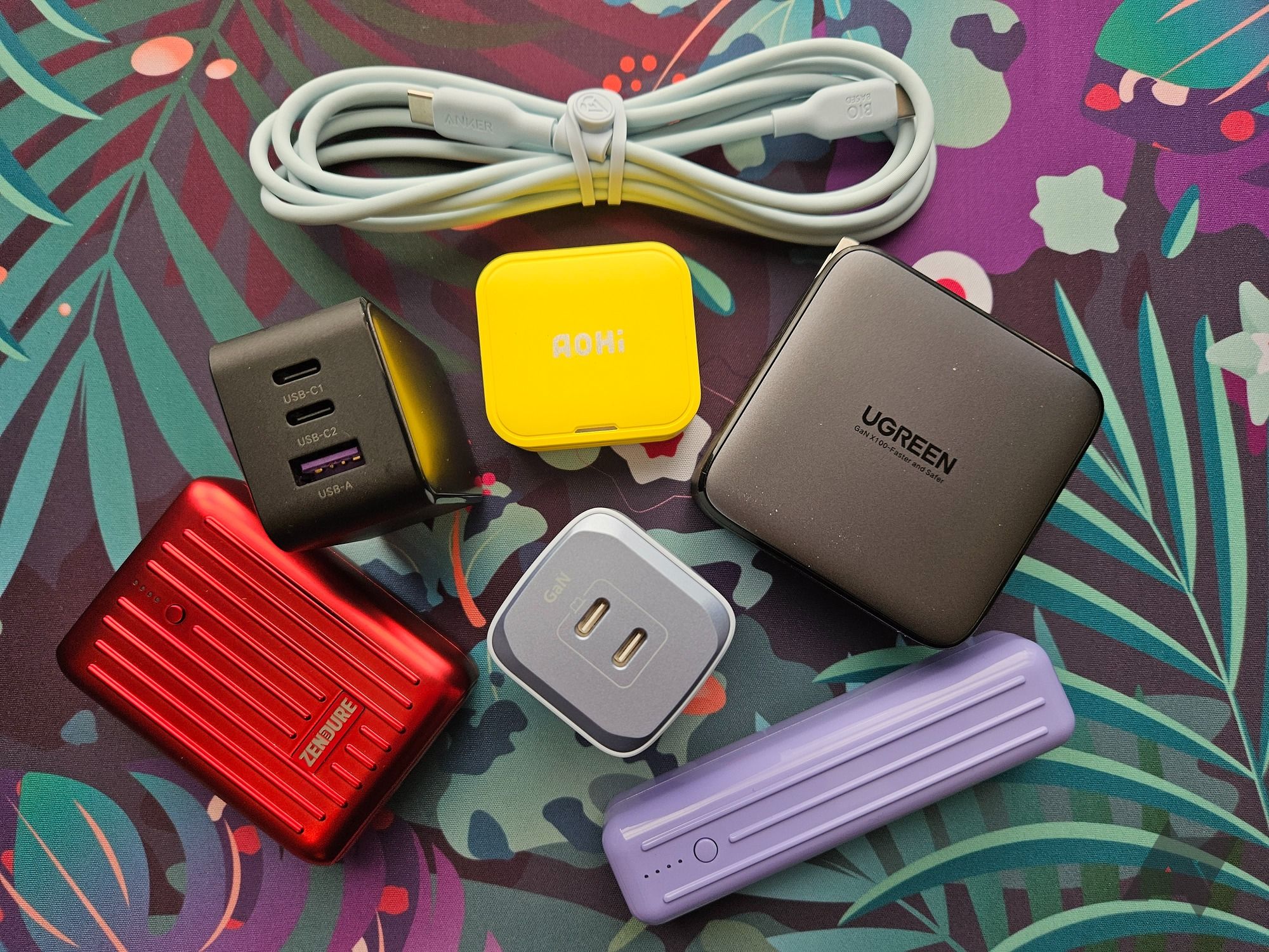 A small assortment of USB-C chargers, power banks, and cables