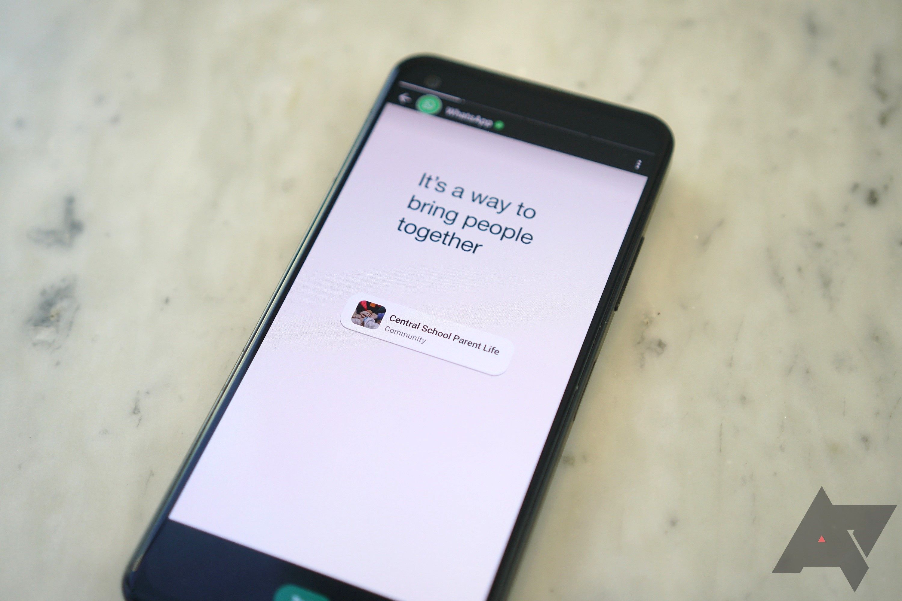 A smartphone showing WhatsApp stories on the screen