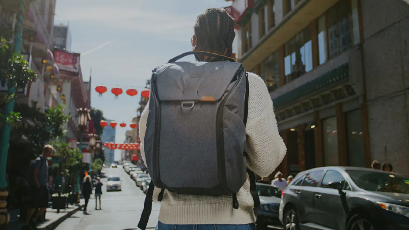  Peak Design Everyday Backpack shown worn on the back of a figure walking down a street