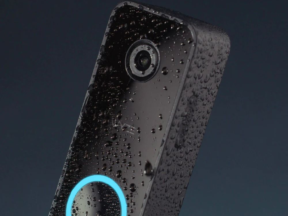 Wyze Video Doorbell v3 with water droplets set against a dark background