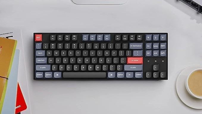 keychron k8 pro keyboard on a desk amongst coffee and notebooks 