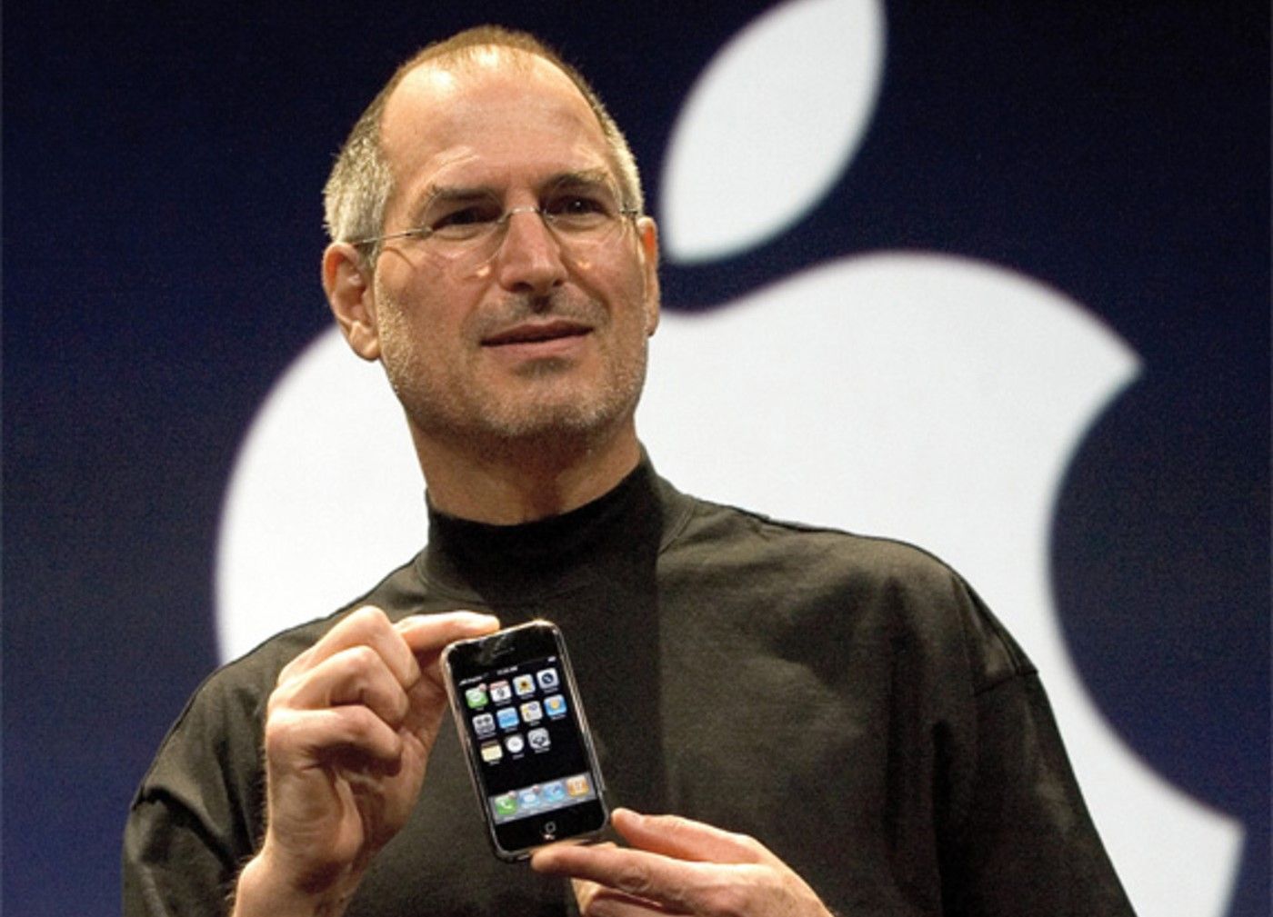 Steve Jobs holding the first iphone during the keynote presentation in 2007.