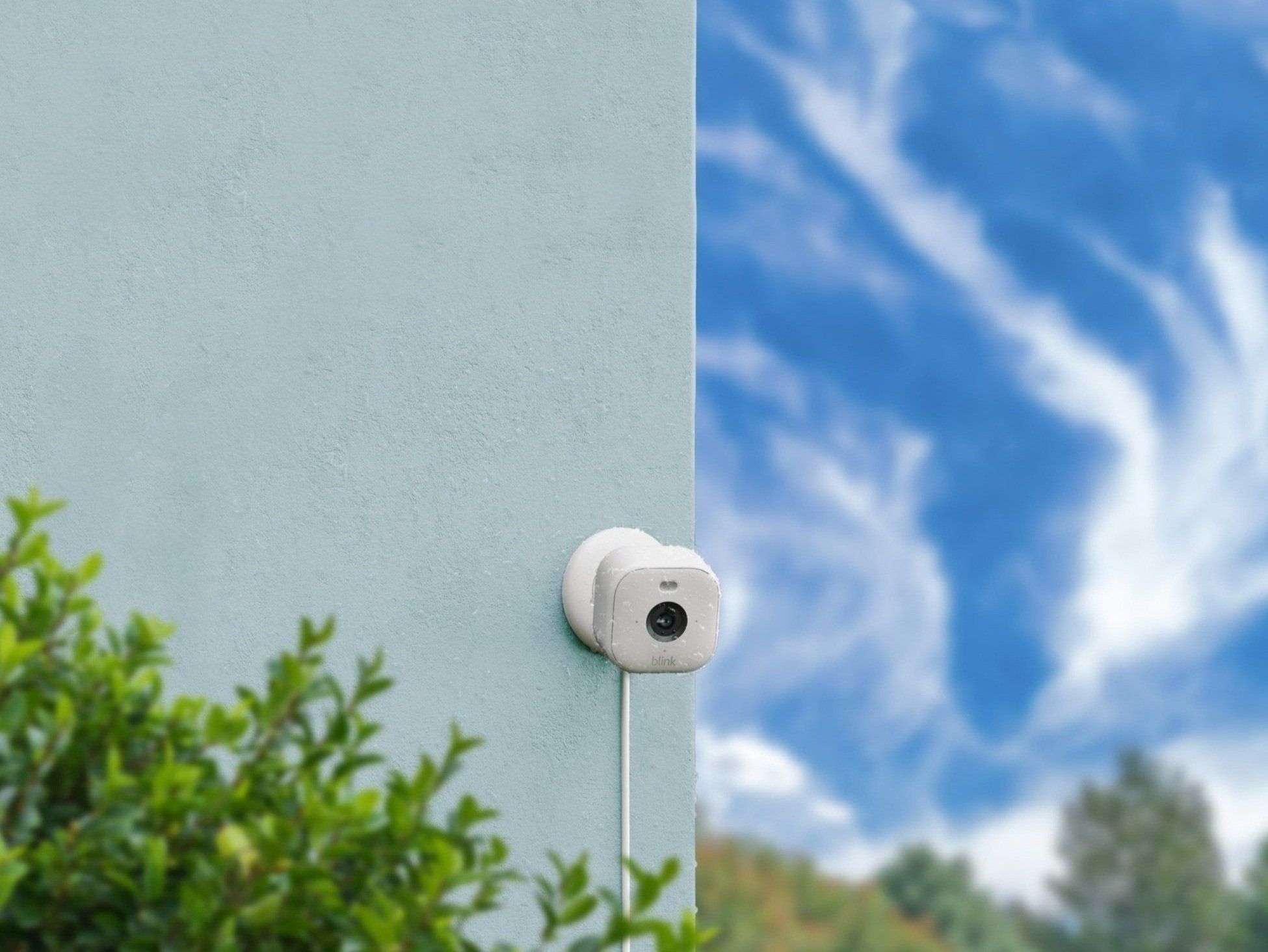 A Blink Mini 2 camera mounted to an outdoor wall