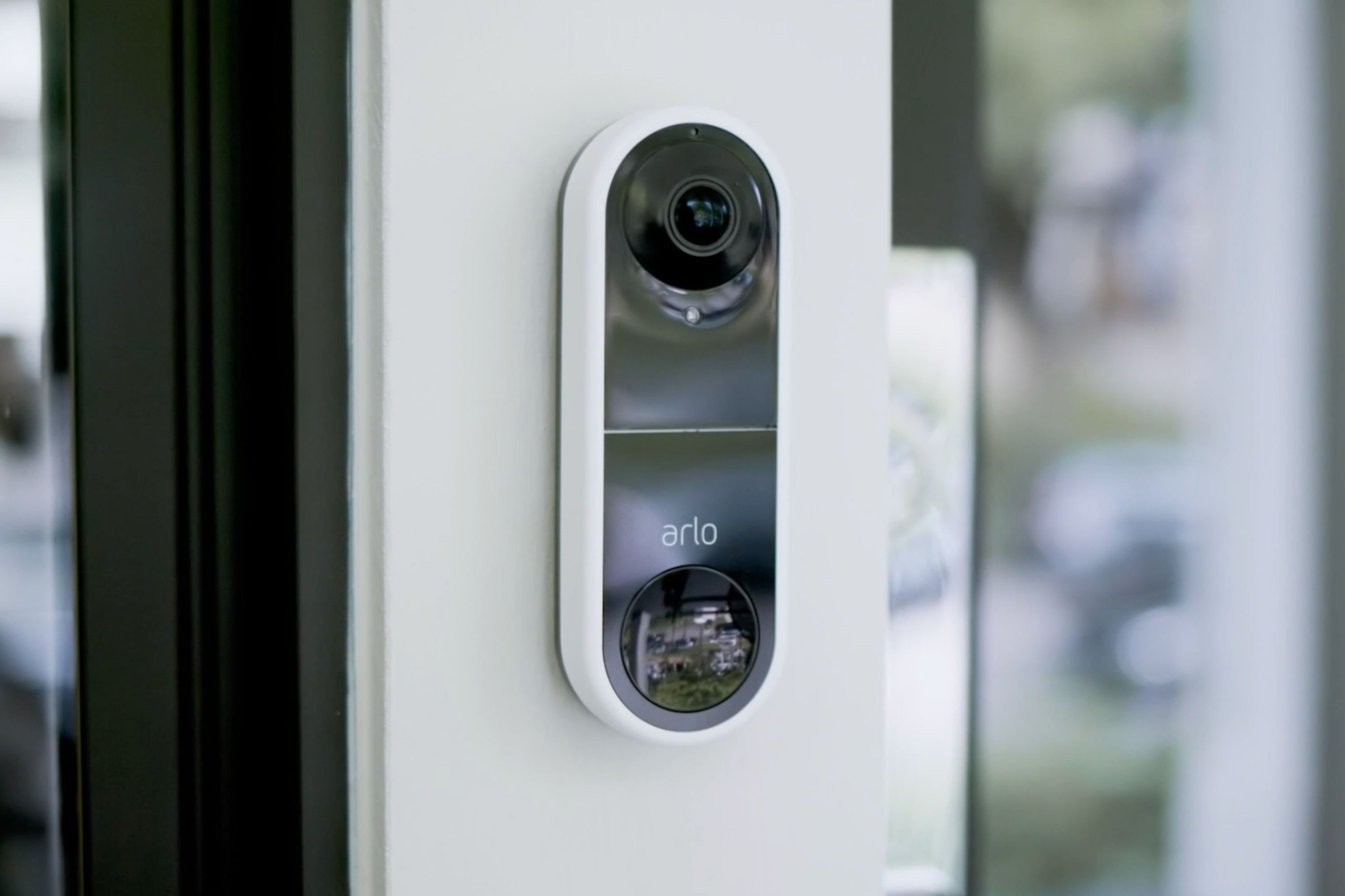Arlo Essential Wired Video Doorbell mounted on wall