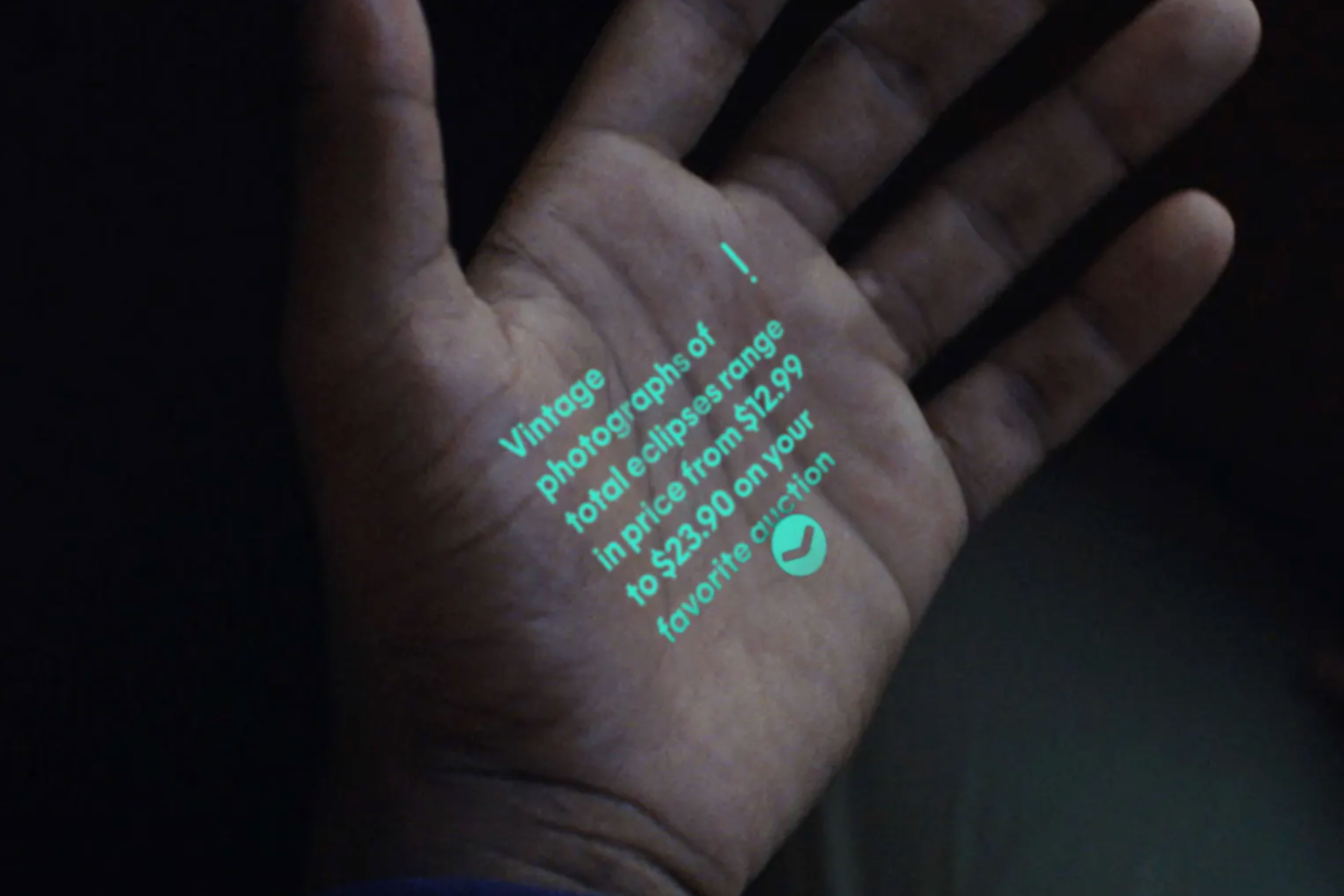 The Humane AI Pin projected onto a hand.