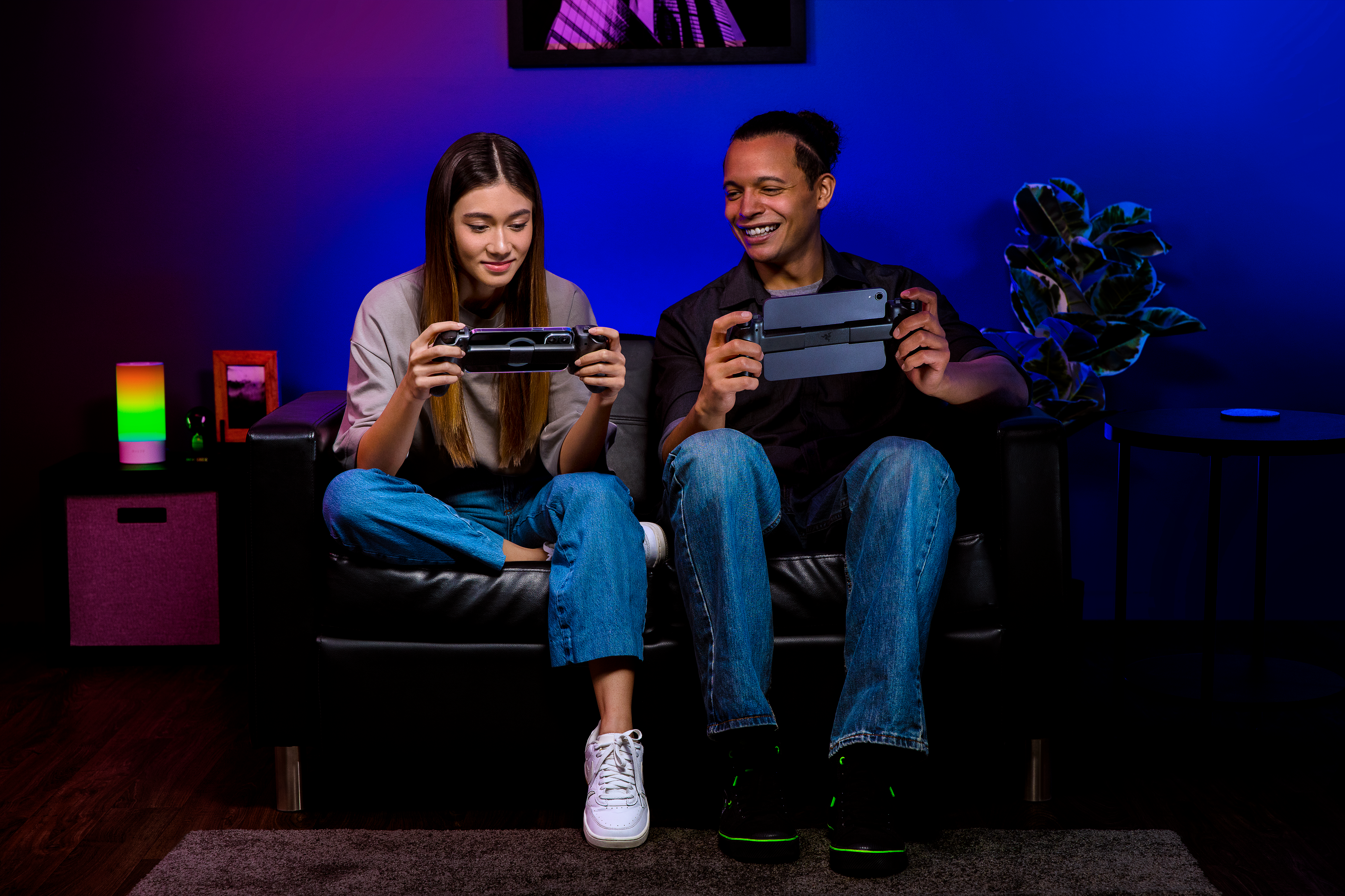 Woman and a man playing games with Kishi Ultra controllers