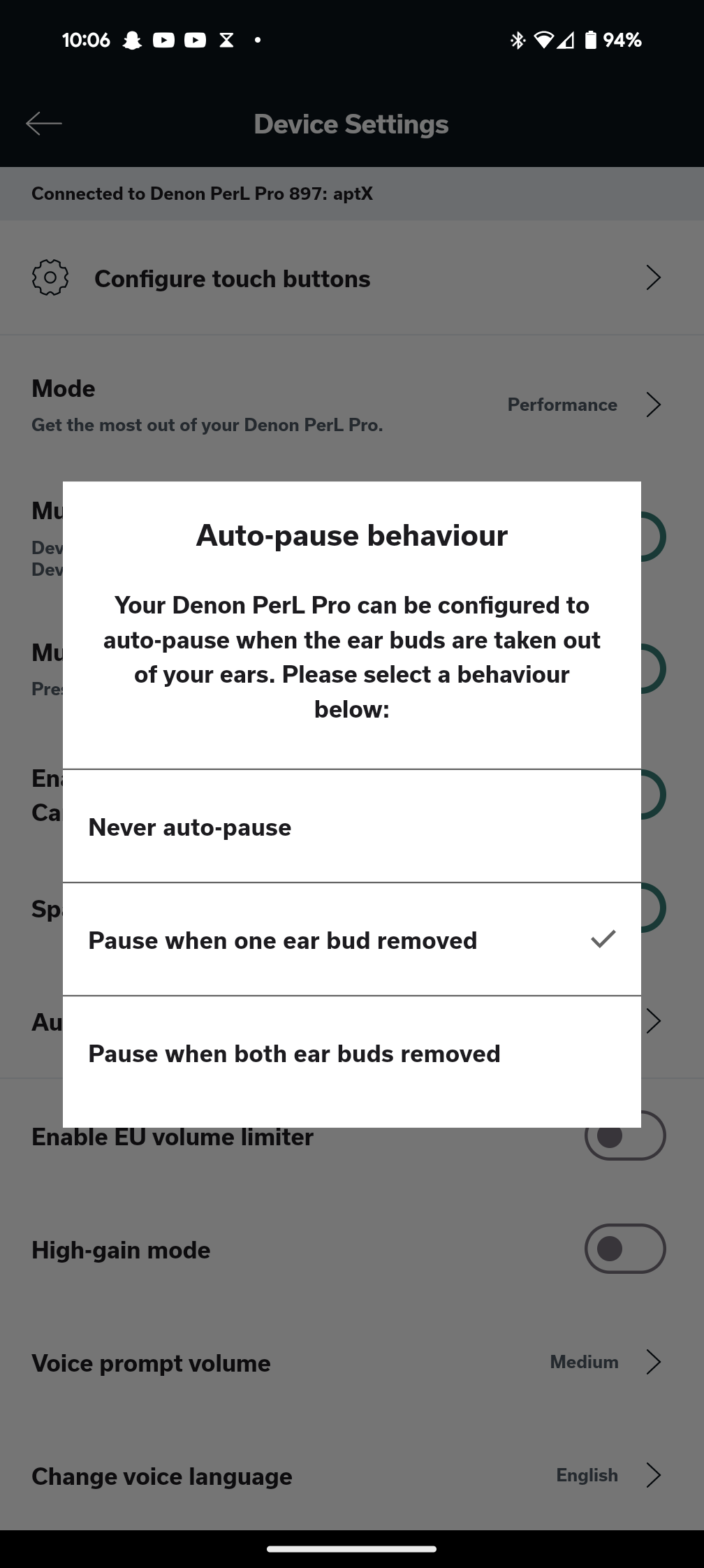 The Auto Pause Behavior option in the Denon Headphones app, which displays options to never pause audio, pause audio when one earbud is removed, or pause audio when both earbuds are removed.
