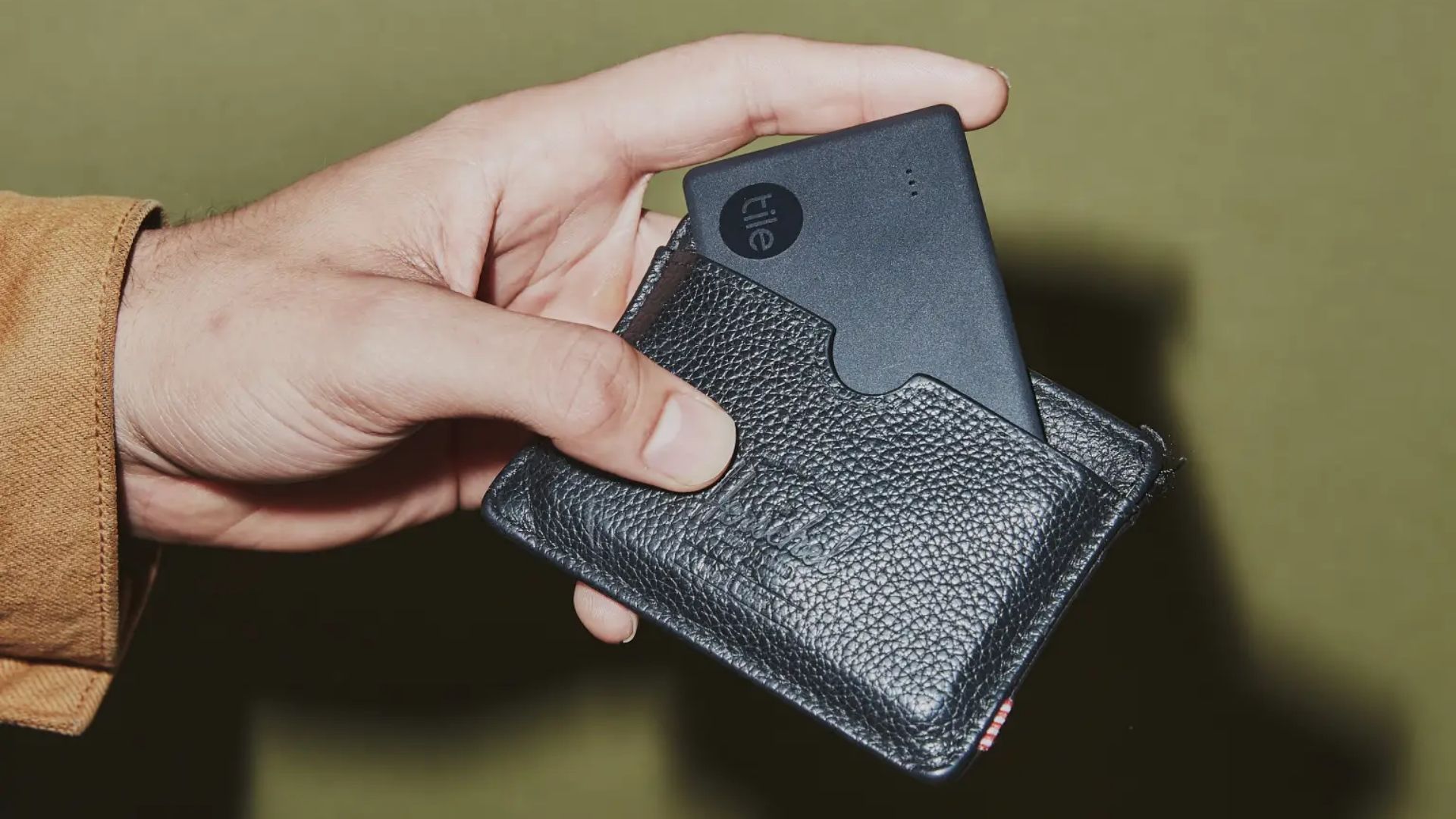 tile slim being placed in a wallet