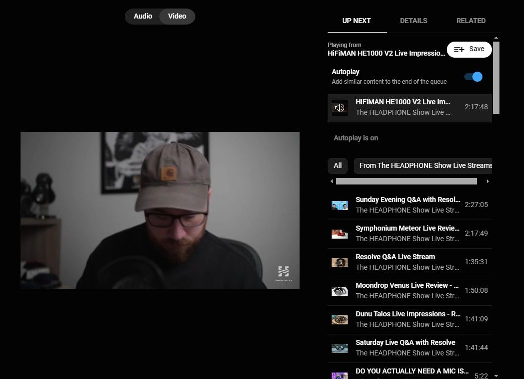 A screenshot of a podcast on the YouTube Music website showing a video playing and video playlist of other episodes on the right.