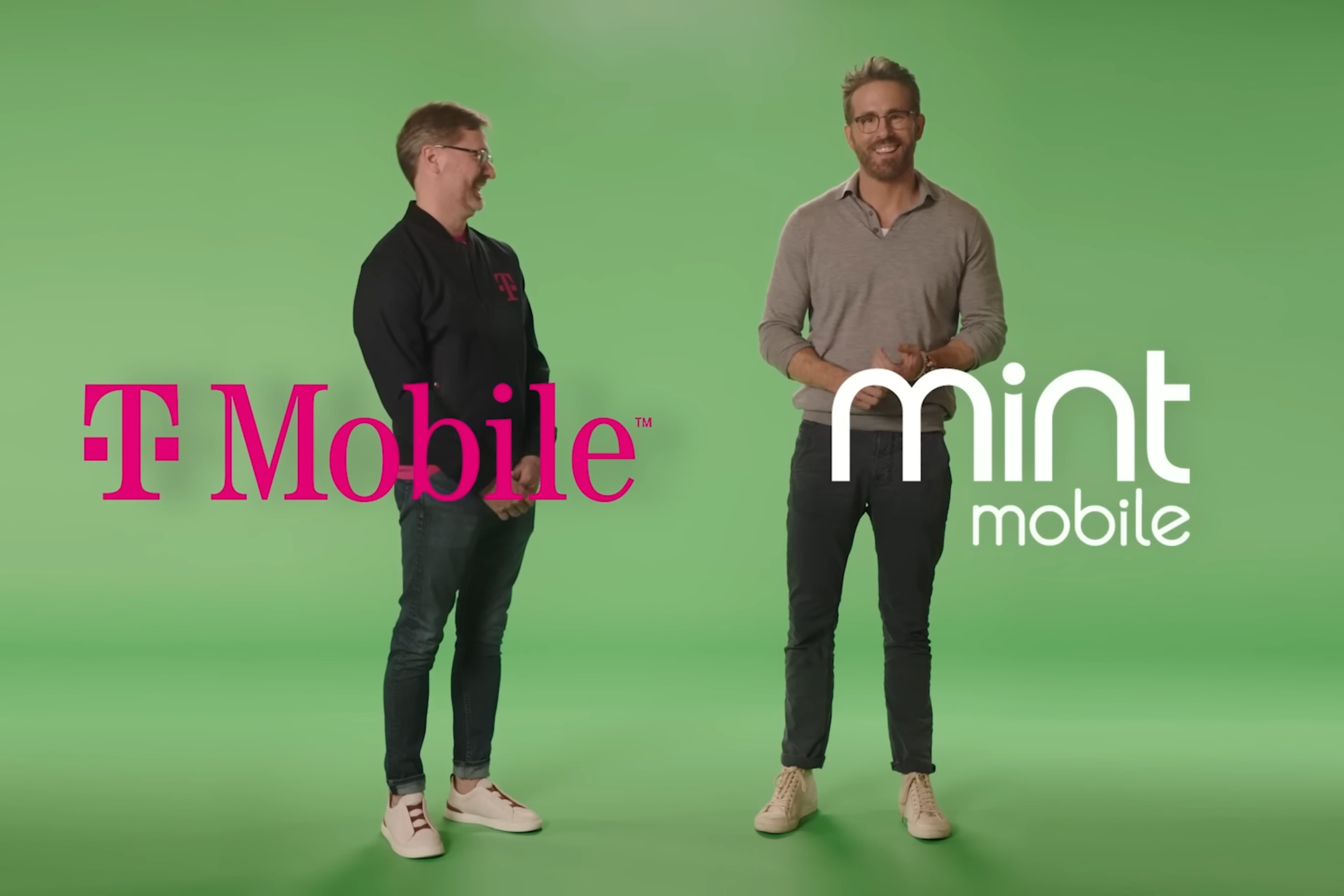 Ryan Reynolds and T-Mobile CEO Mike Sievert standing in front of green screen