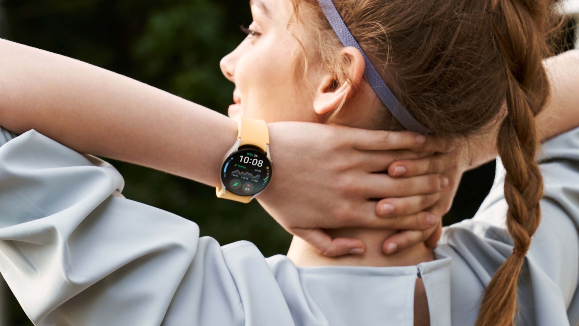 A person wearing the Samsung Galaxy Watch 6 in gold